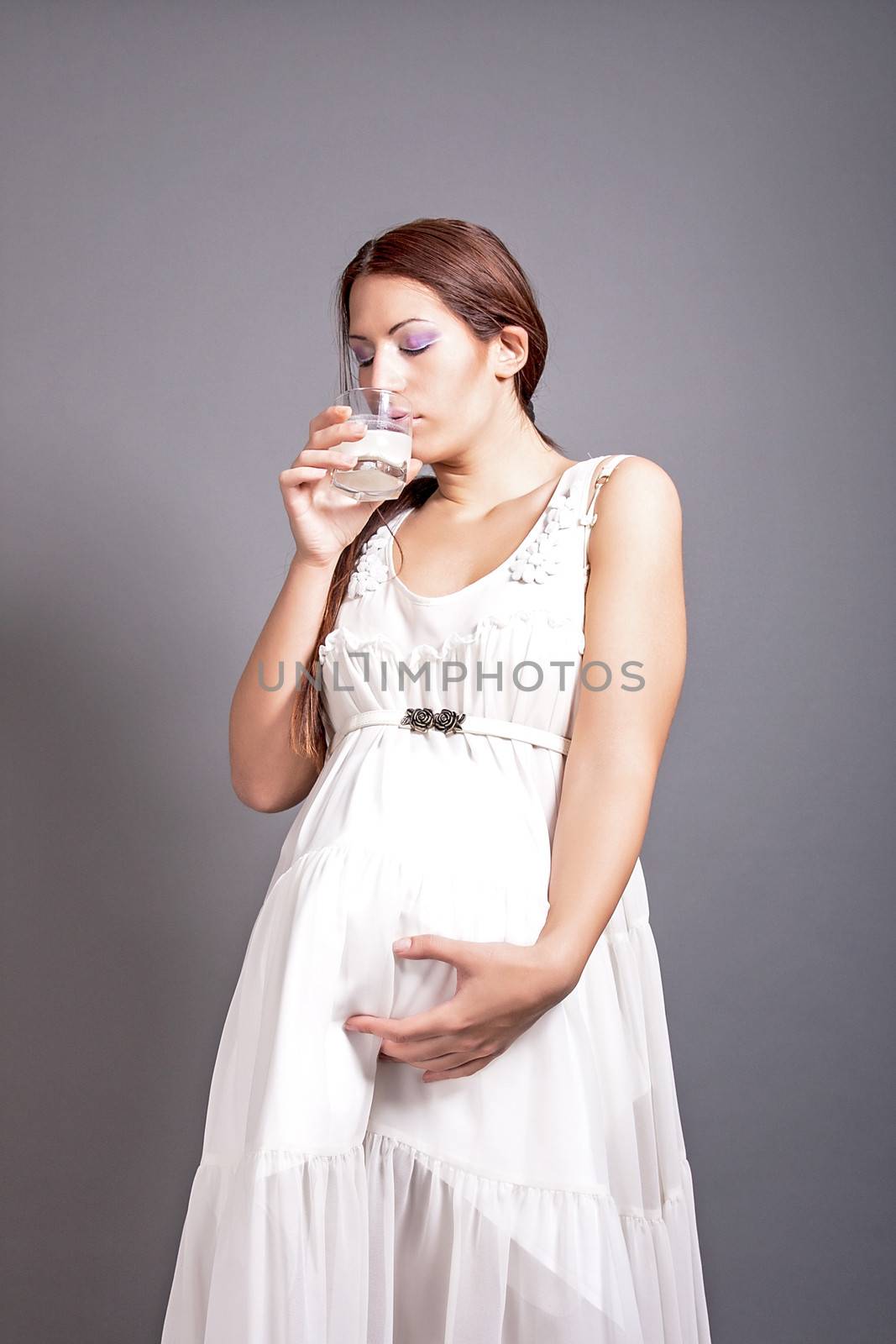portrait of pregnant woman drinking milk