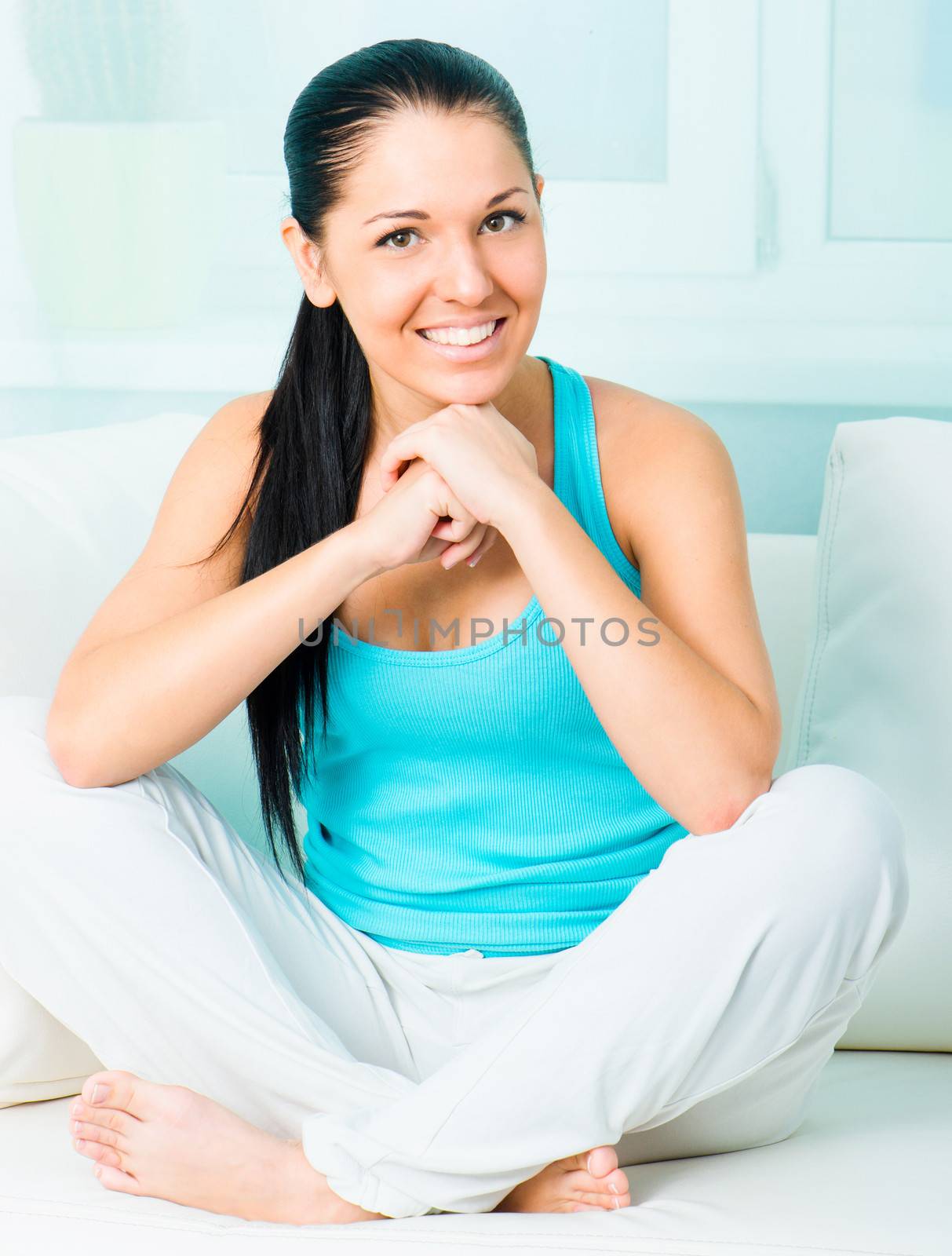 beautiful smiling young woman sitting on the sofa