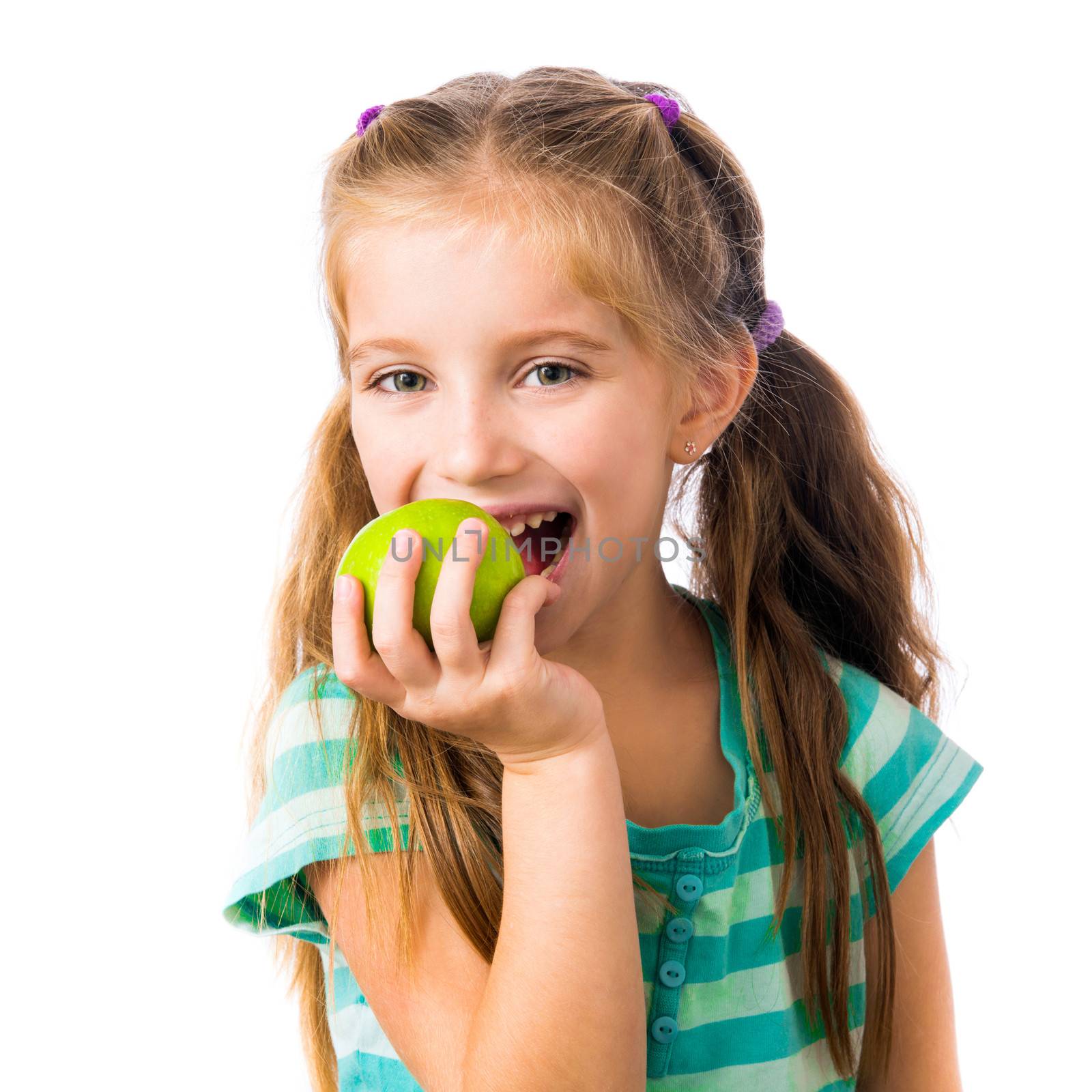 little girl biting an apple isolated on white background