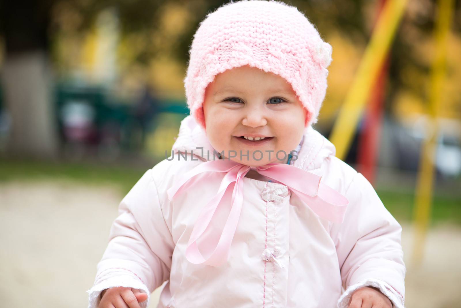 smiling little baby on the playground