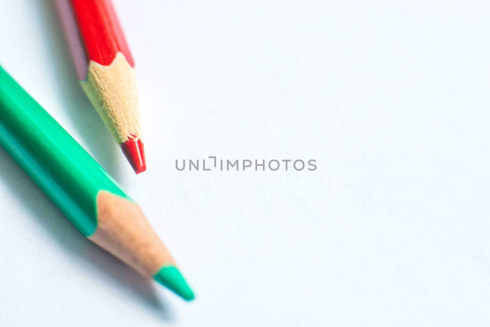 green and red pencil on white paper