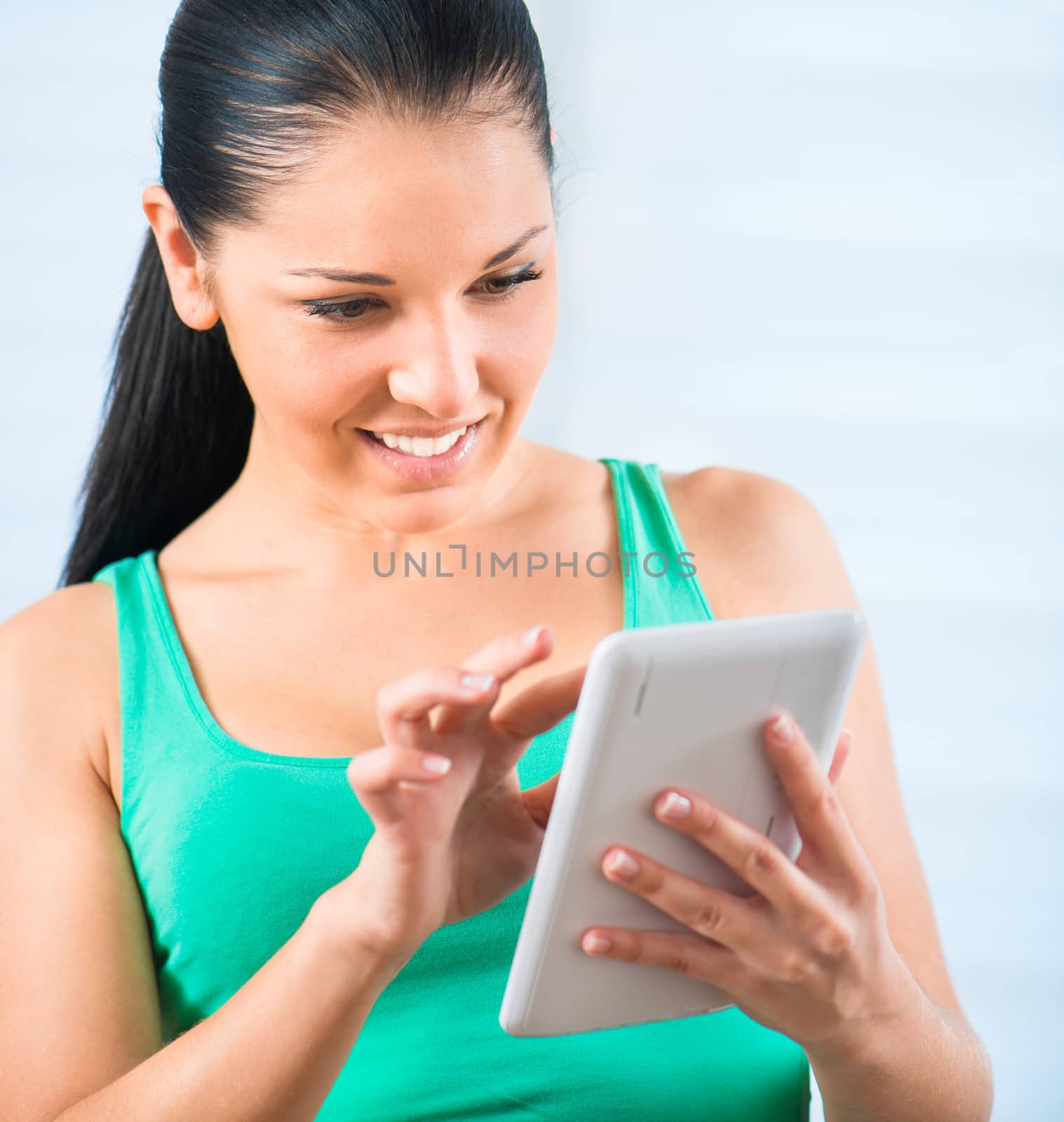 young smiling brunette woman holding a white TouchPad
