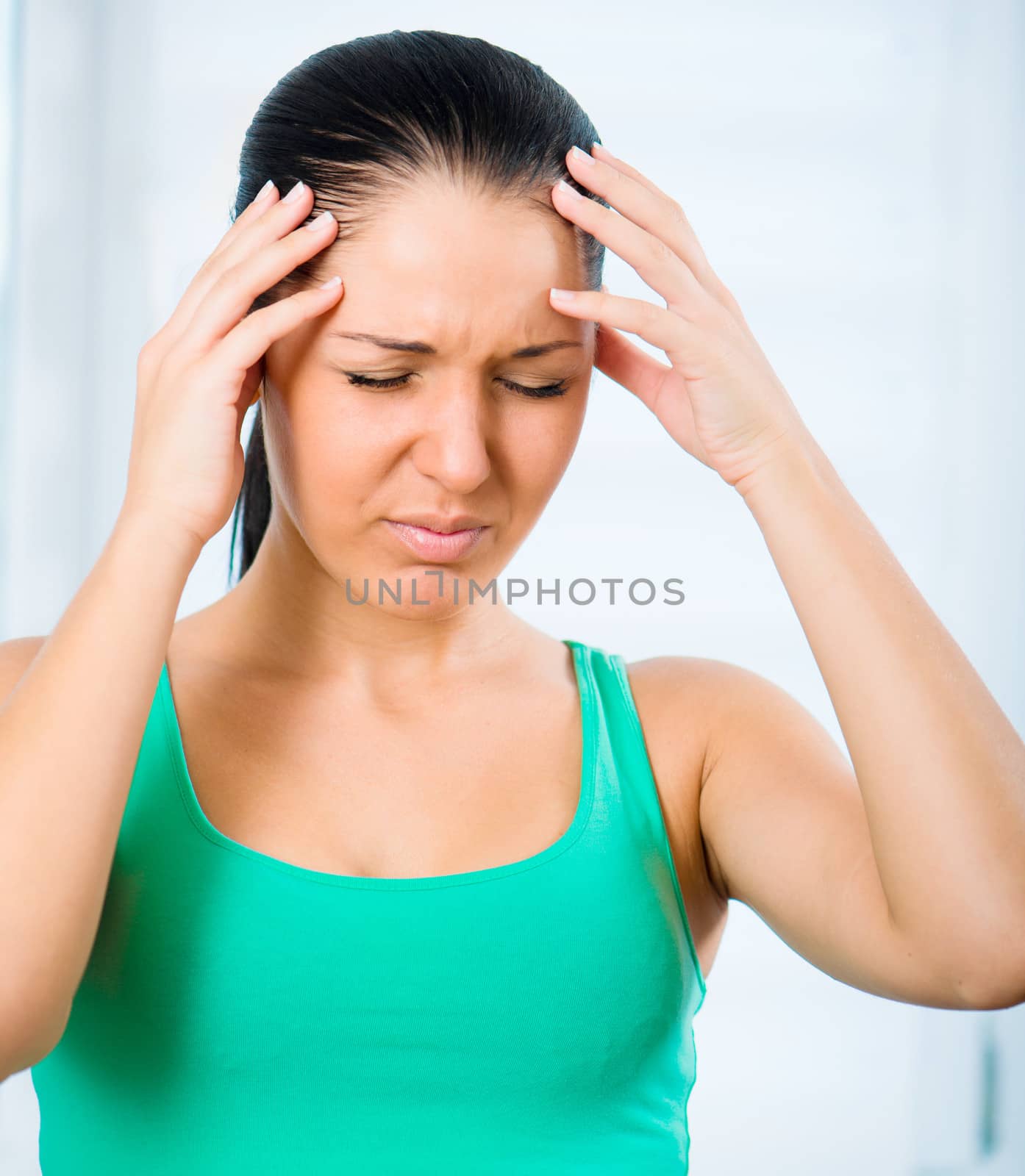 A young woman with headache holding head