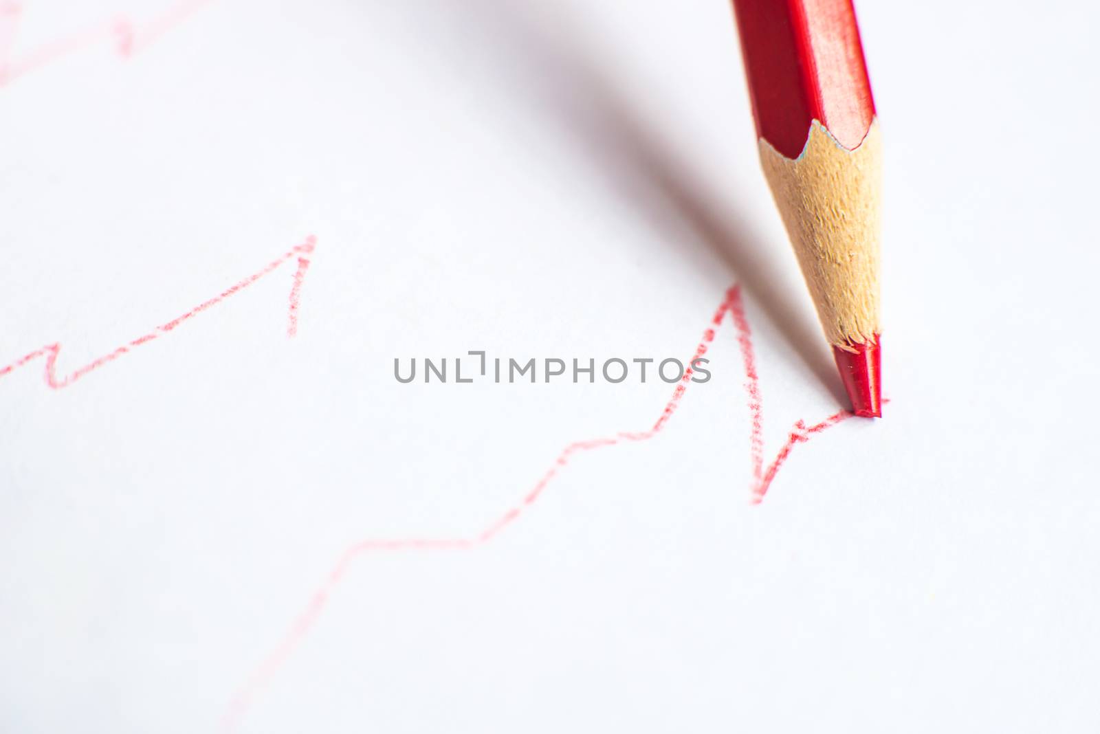 red and green pencil with graph on white paper