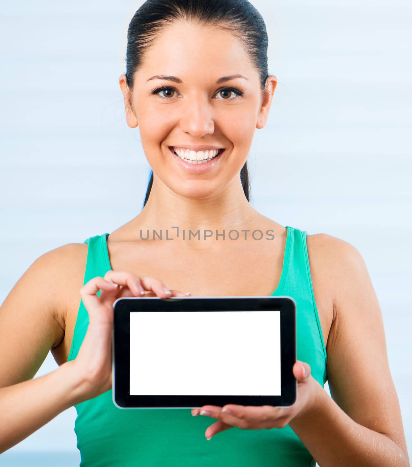 young smiling brunette woman holding a touch pad