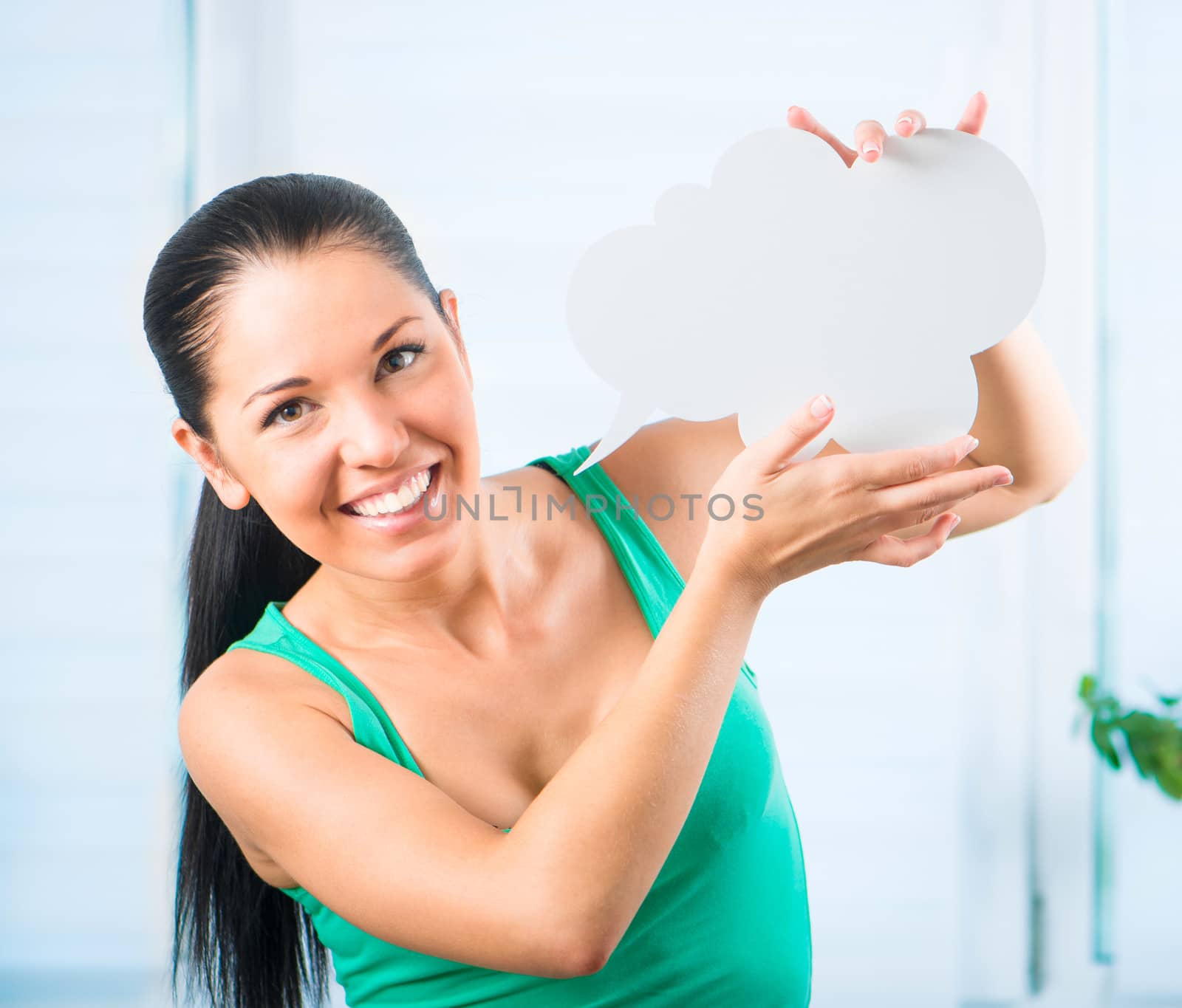 young smiling brunette woman holding a white cloud for text