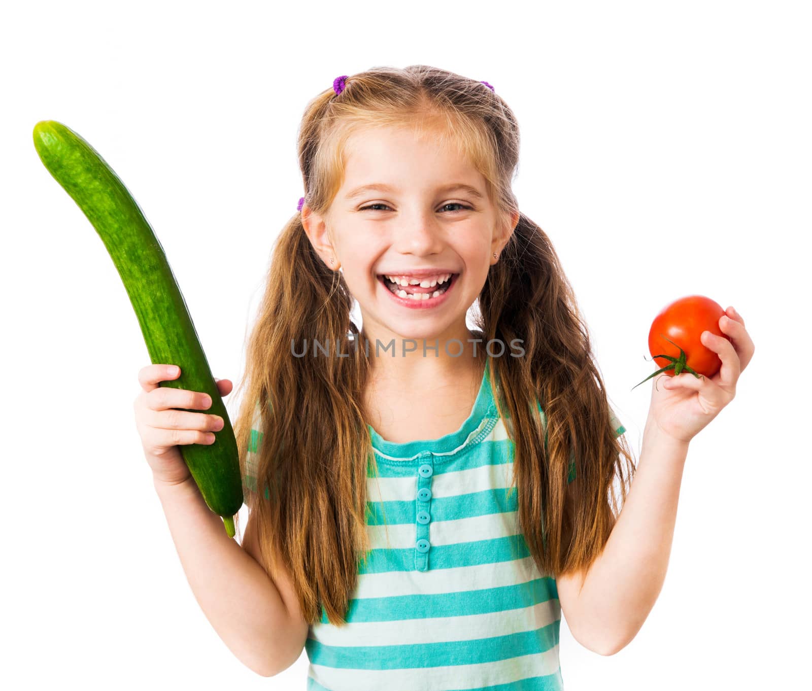 little smiling girl with a tomato and cucumber isolated on white background