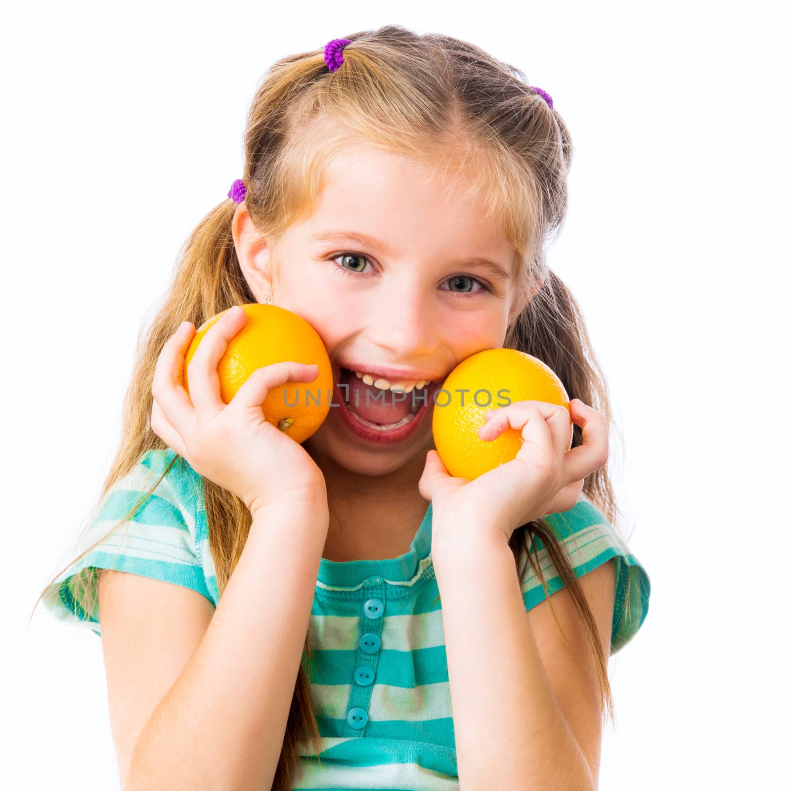 little smiling girl with two oranges isolated on white background