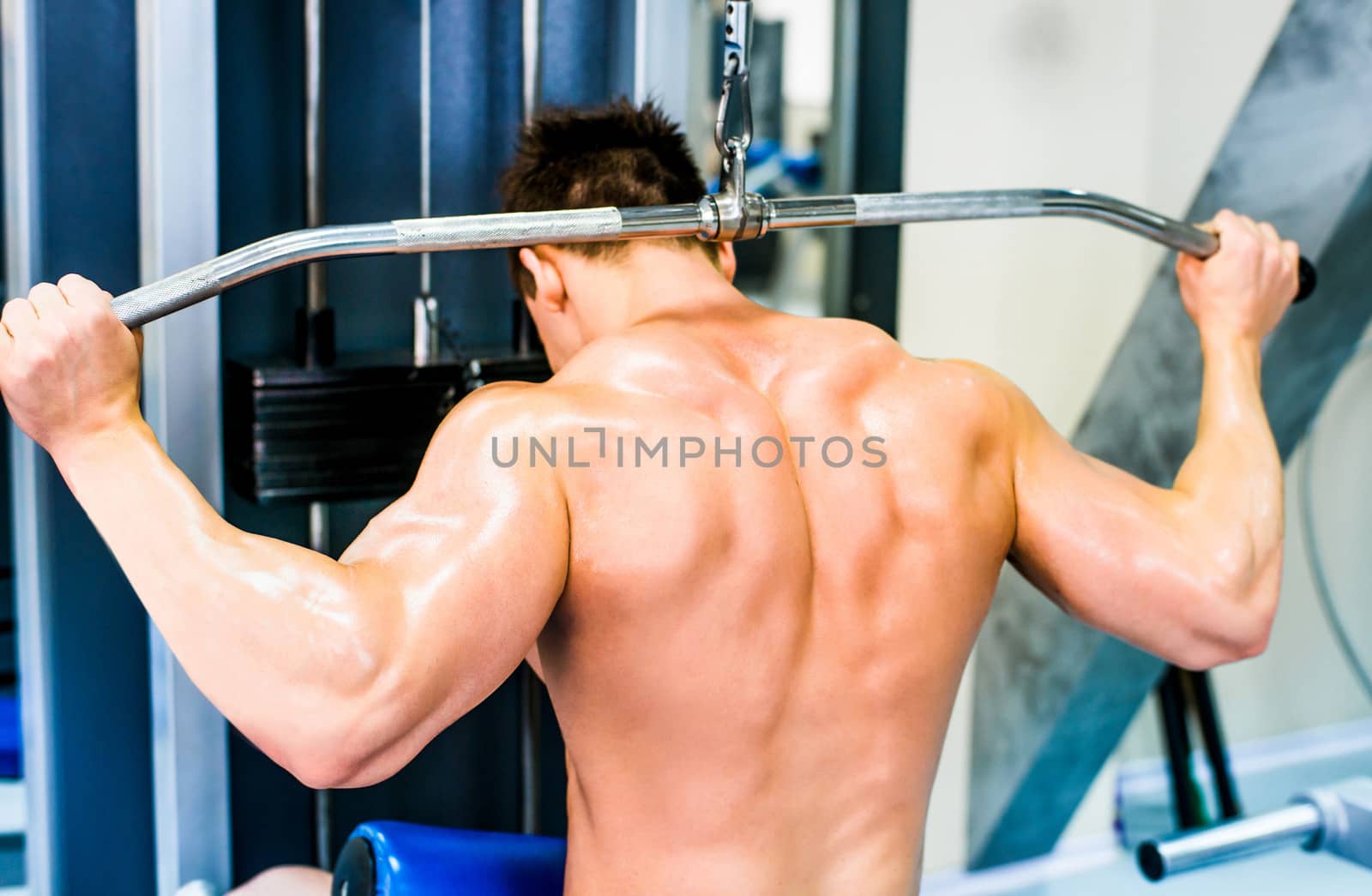 bodybuilder doing exercises on the simulator