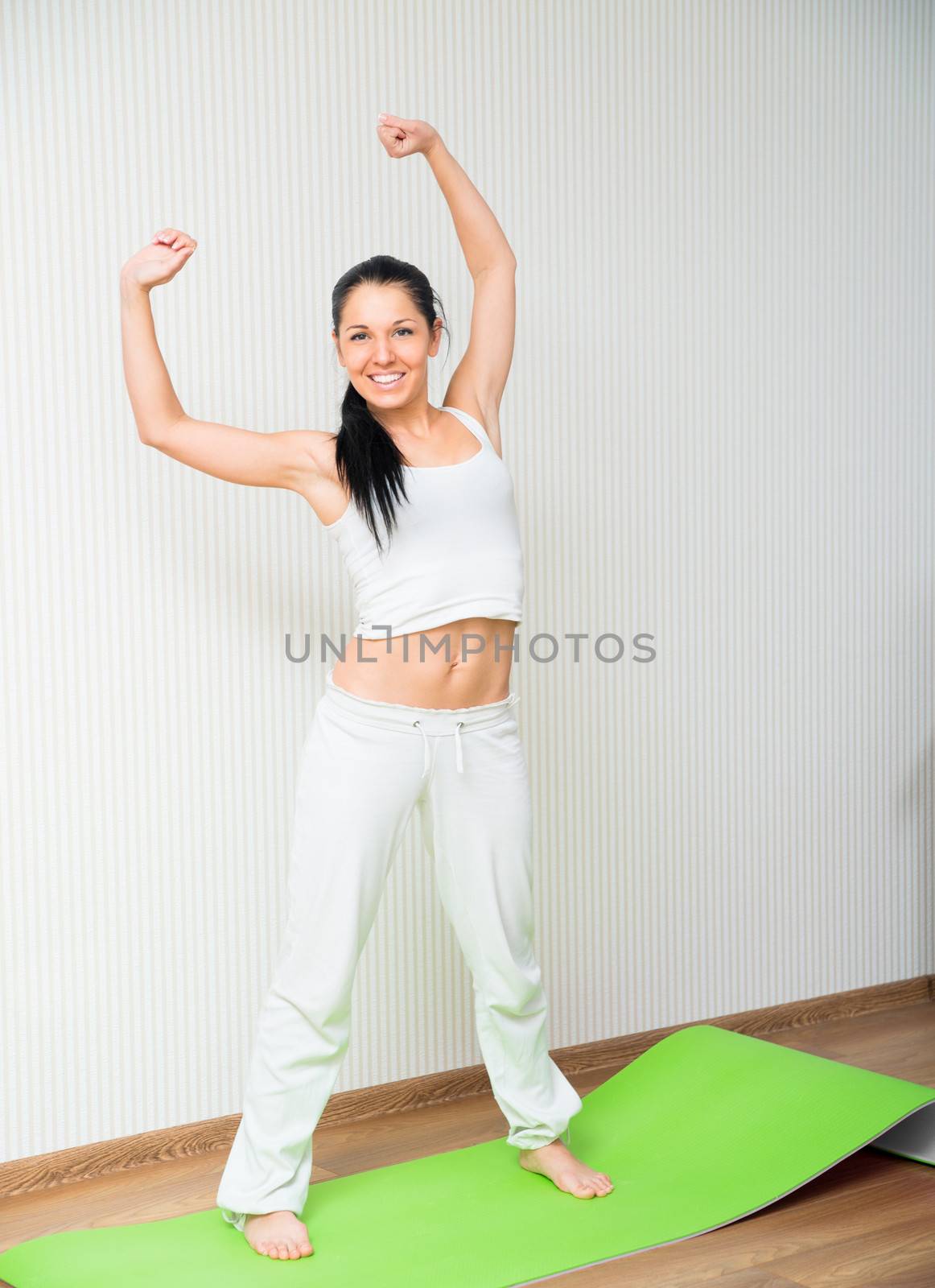 Portrait of young sporty girl doing exercise in gym