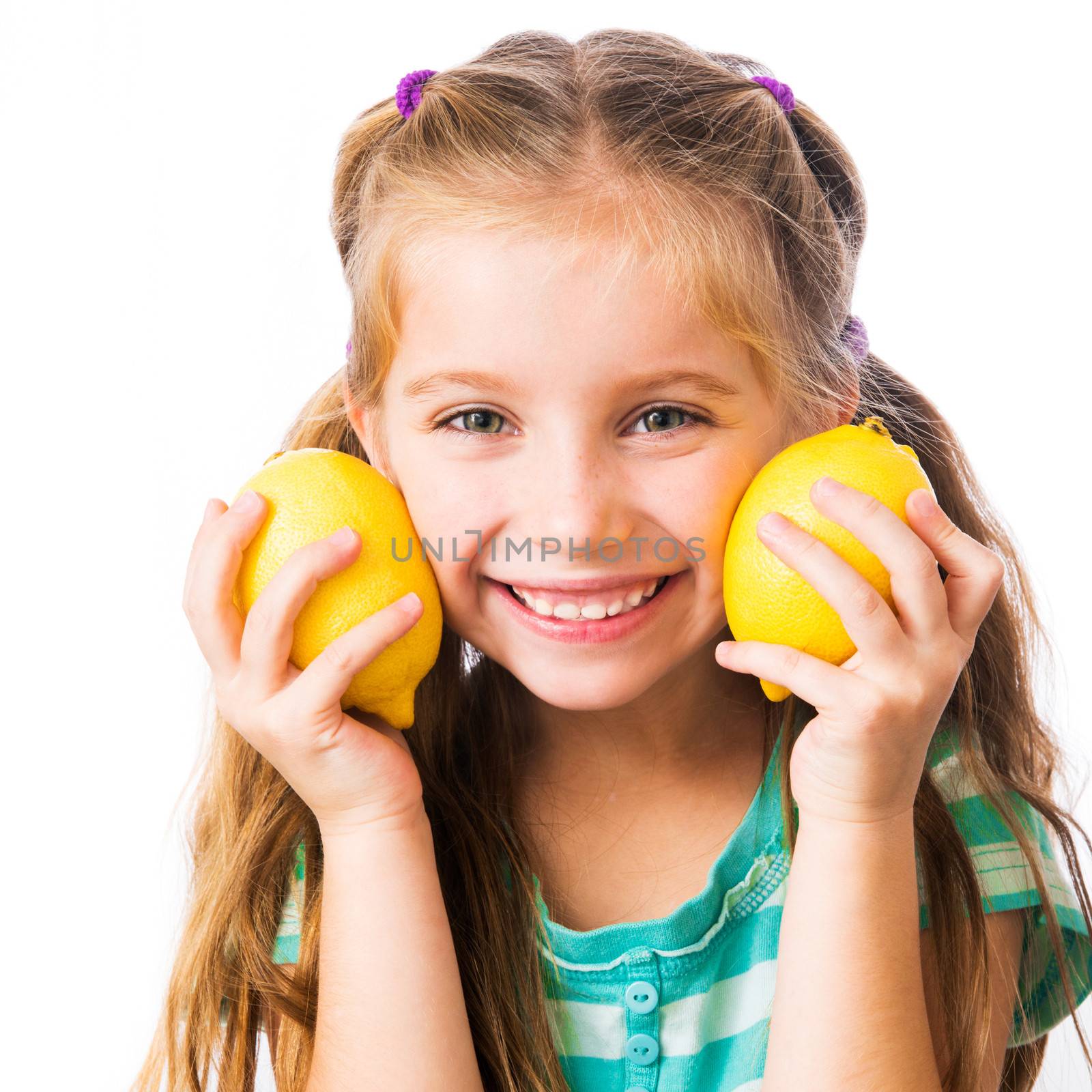 little girl with two lemons isolated on white background