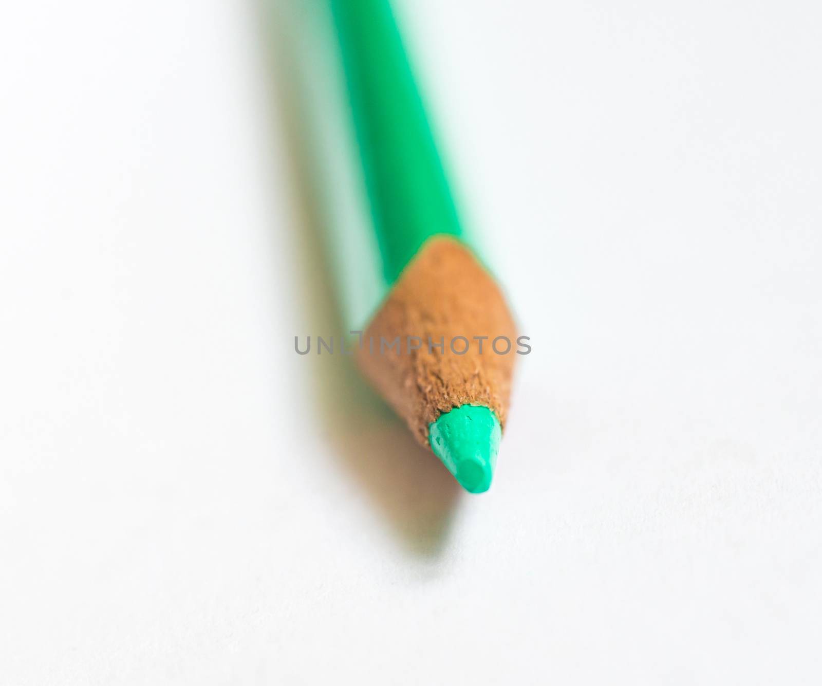 green pencil on white paper