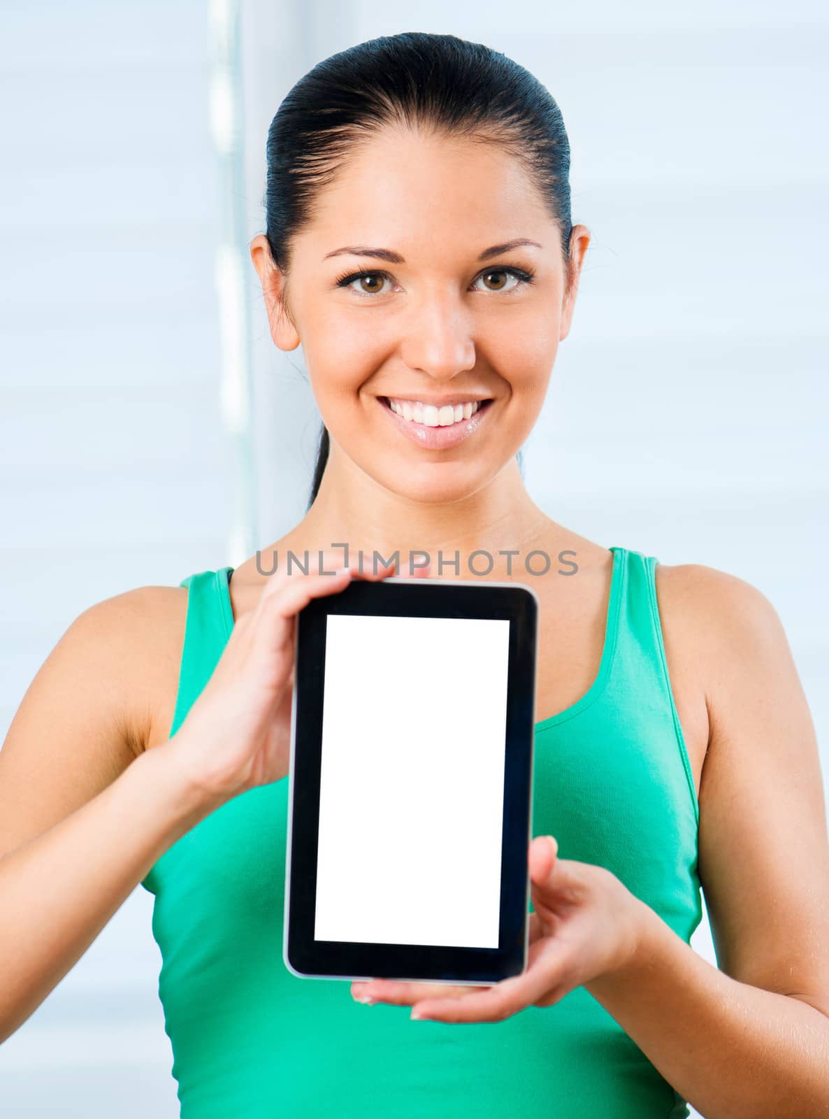 young smiling brunette woman holding a touch pad with