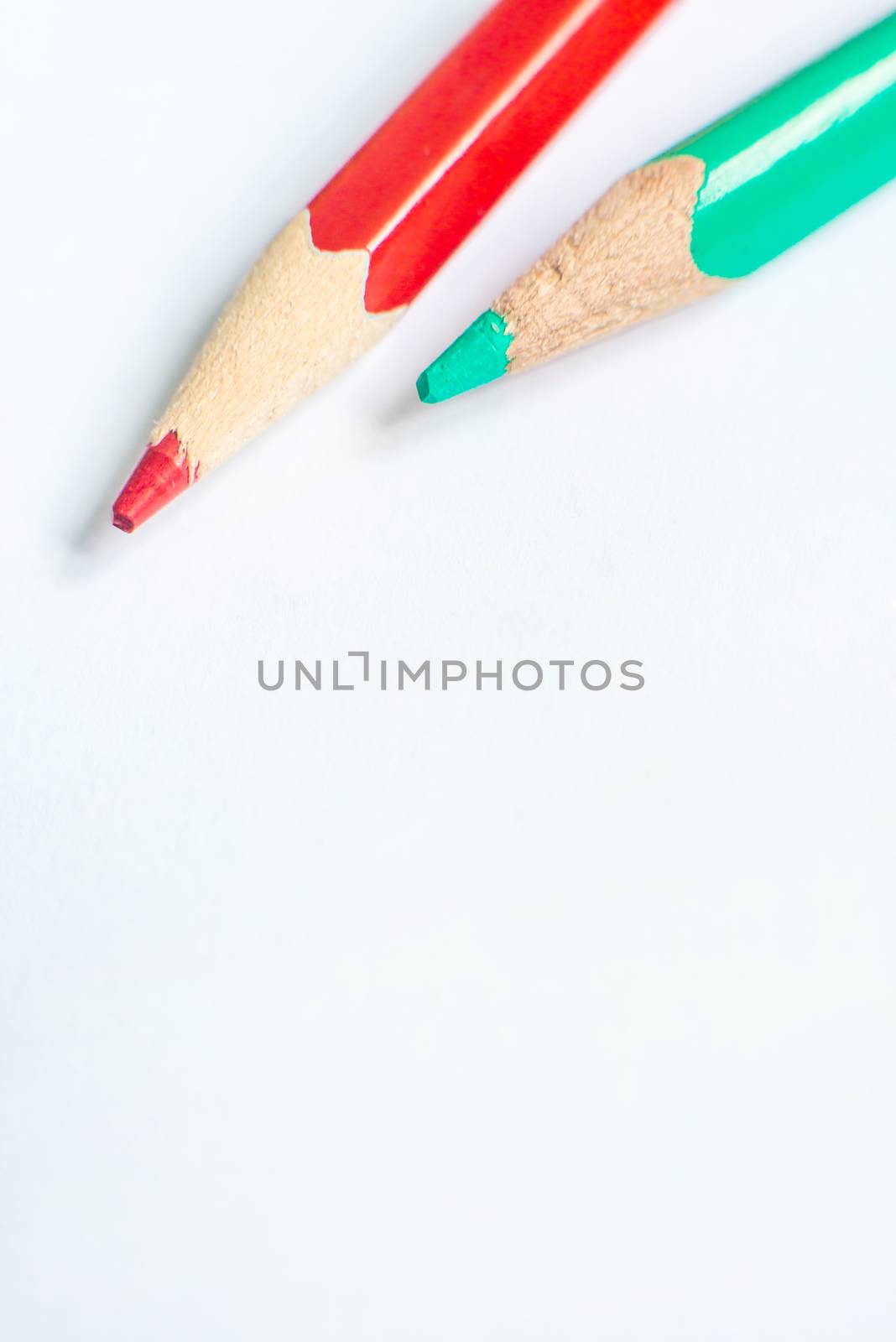 green and red pencil on white paper