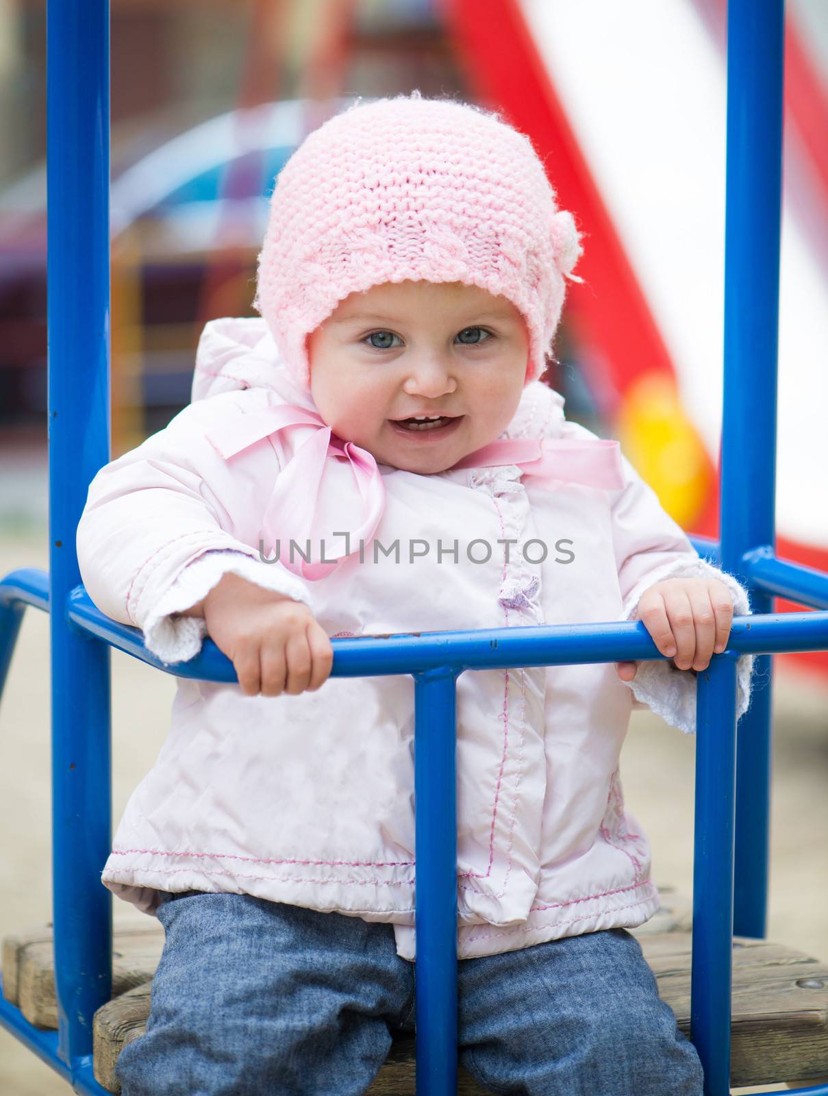 cute little baby swinging at the park