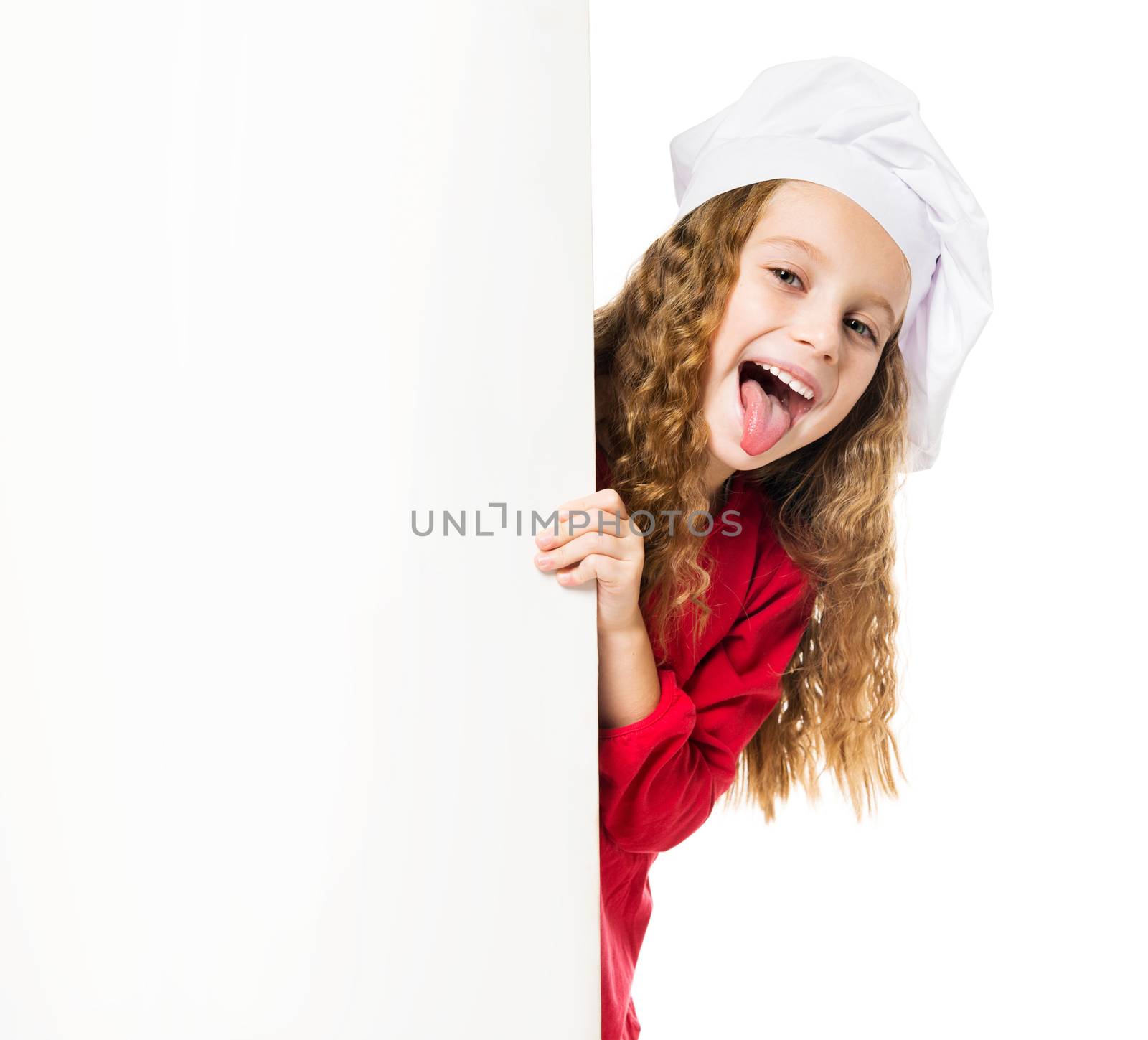 little girl in chef hat with a white board shows tongue