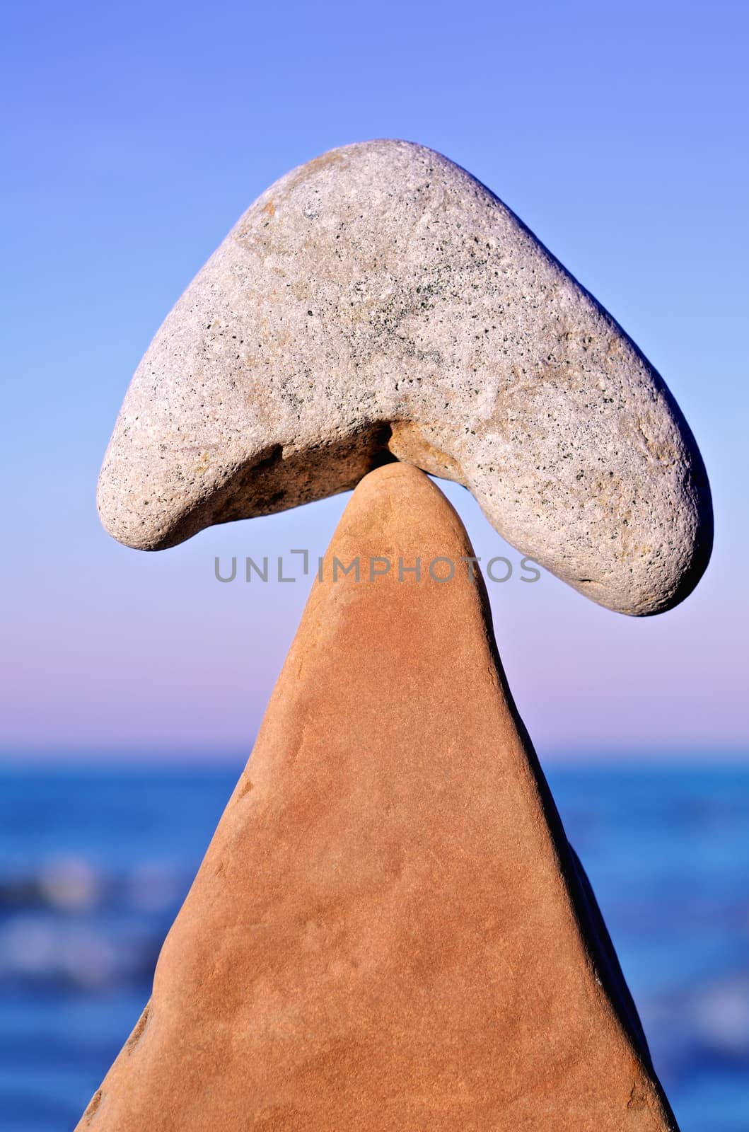 Balancing of pebbles on the top of triangle stone