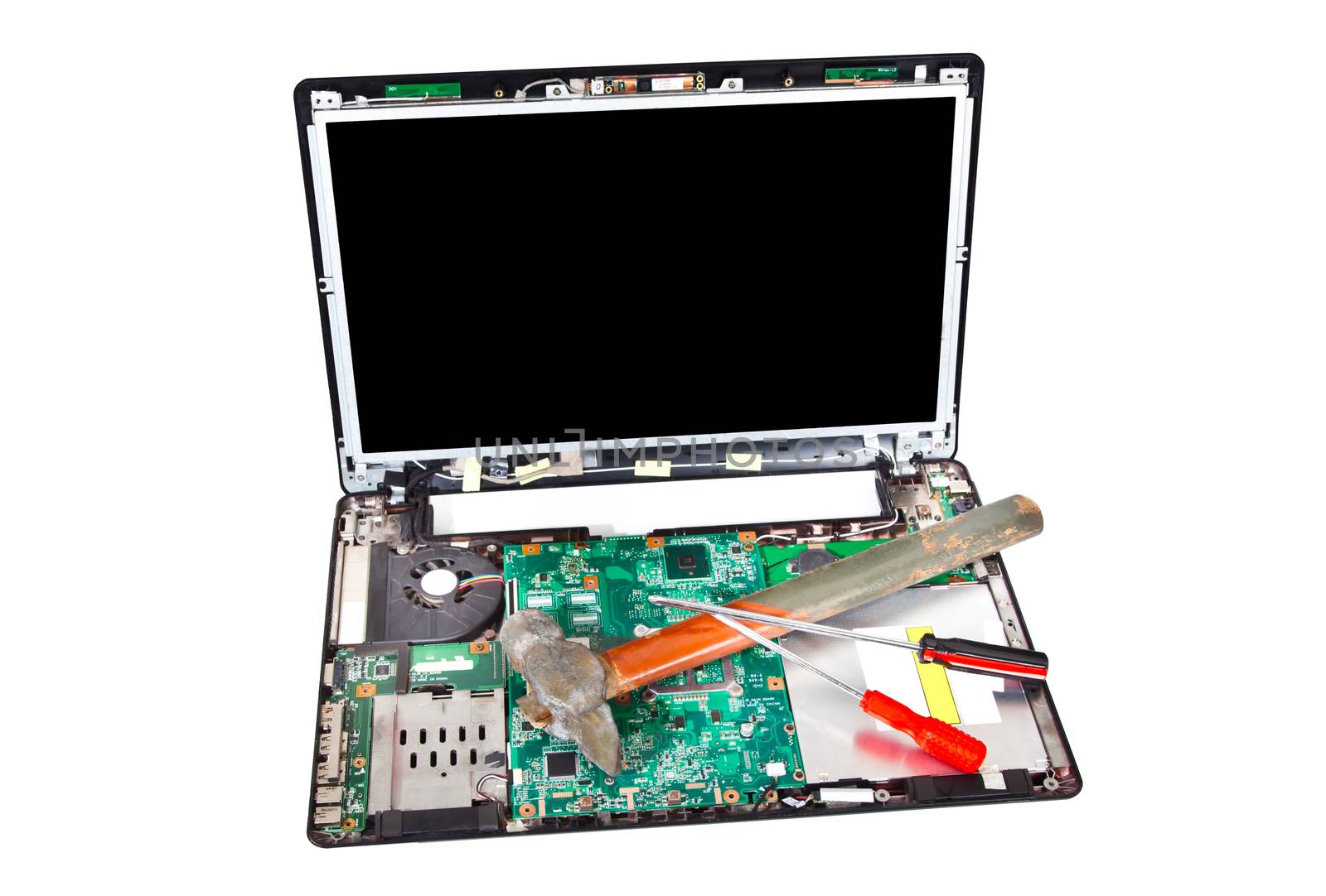 Laptop disassembled with hammer and screwdrivers on it by RawGroup