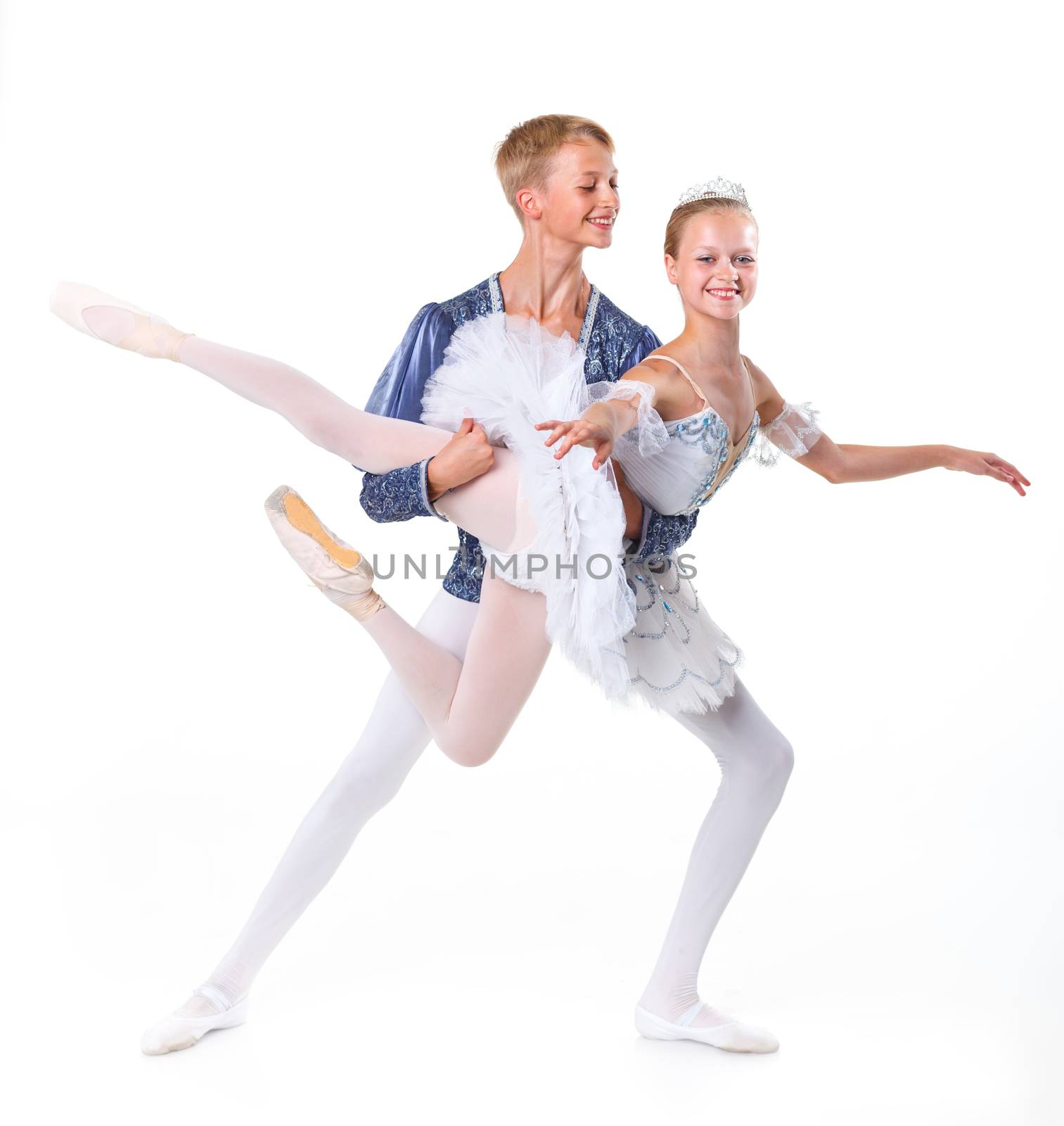 Couple of young ballet dancers posing over isolated white background