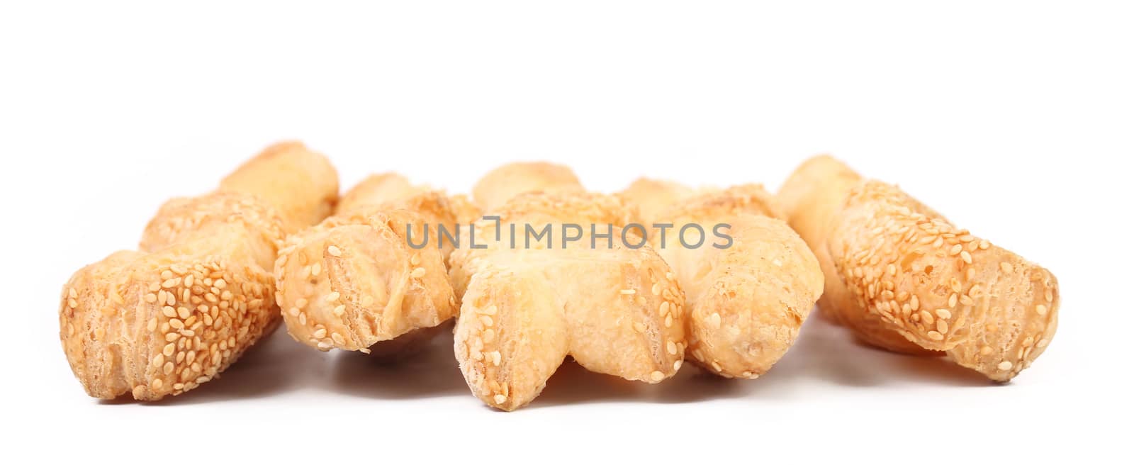 Many cheese sticks with seeds. Isolated on a white background