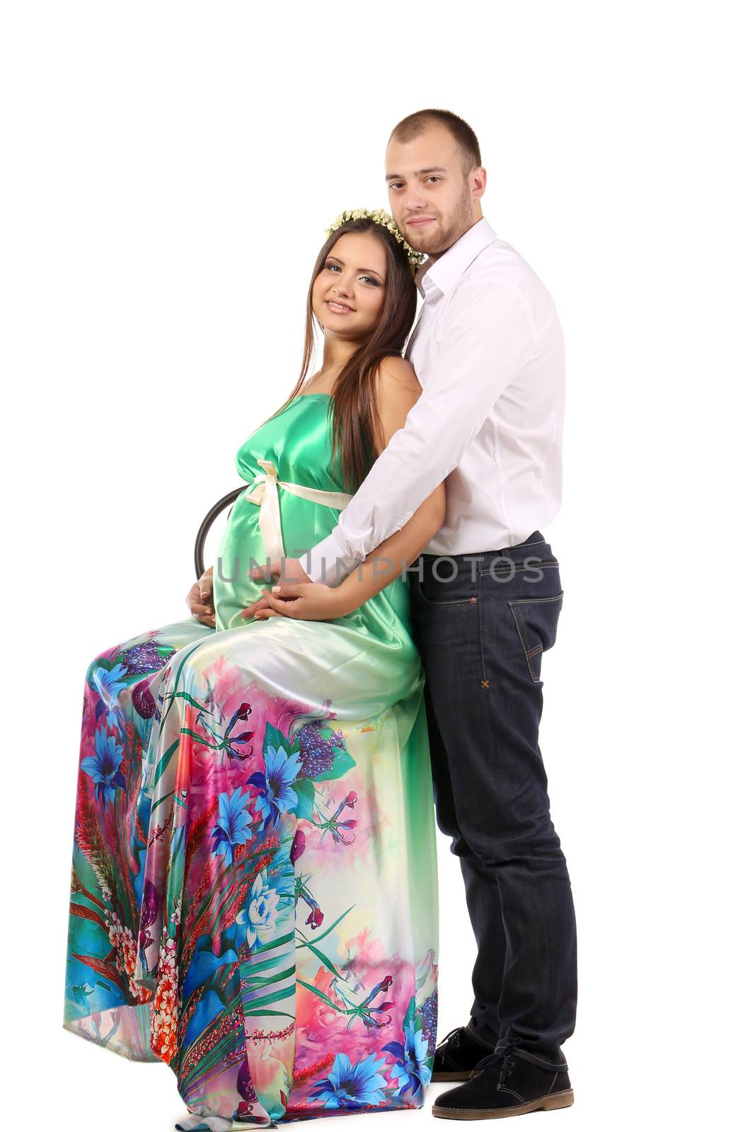Wiew of a beautiful pregnant girl with her husband.