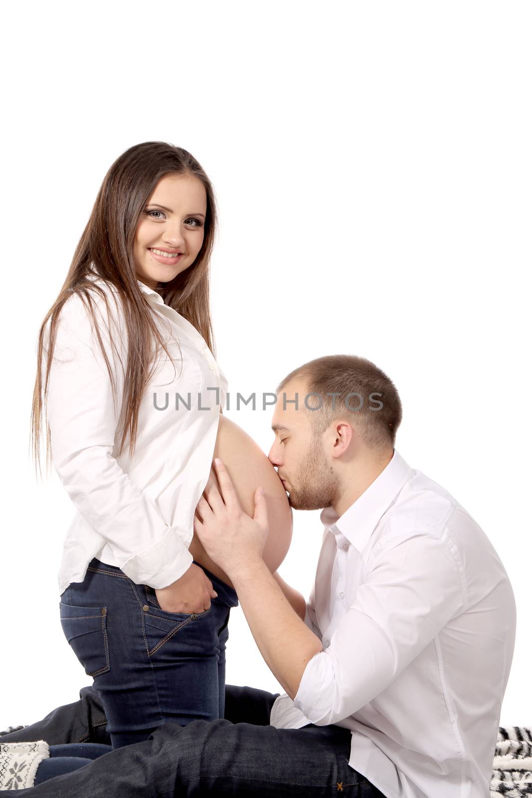 Husband is kissing the pregnant woman isolated on white background