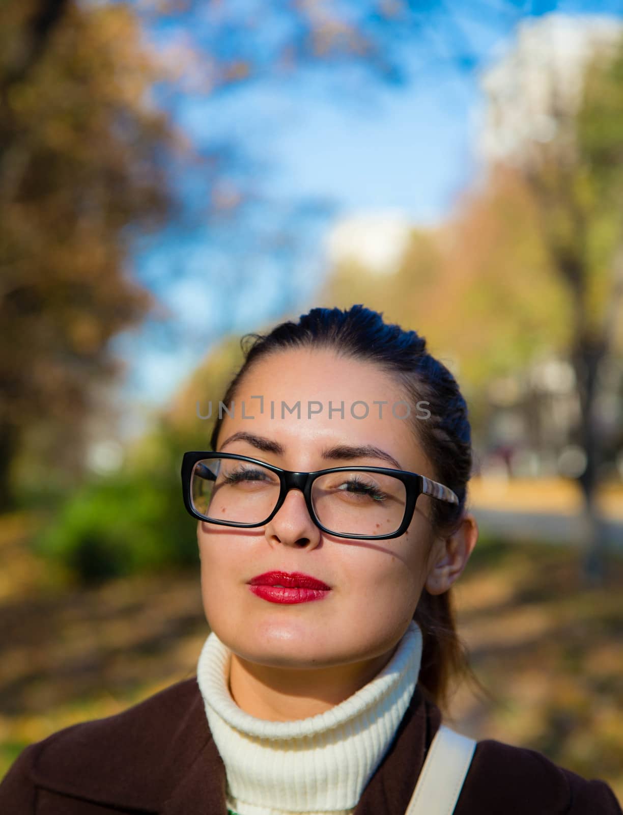 Beautiful woman on the autumn background. Portrait.