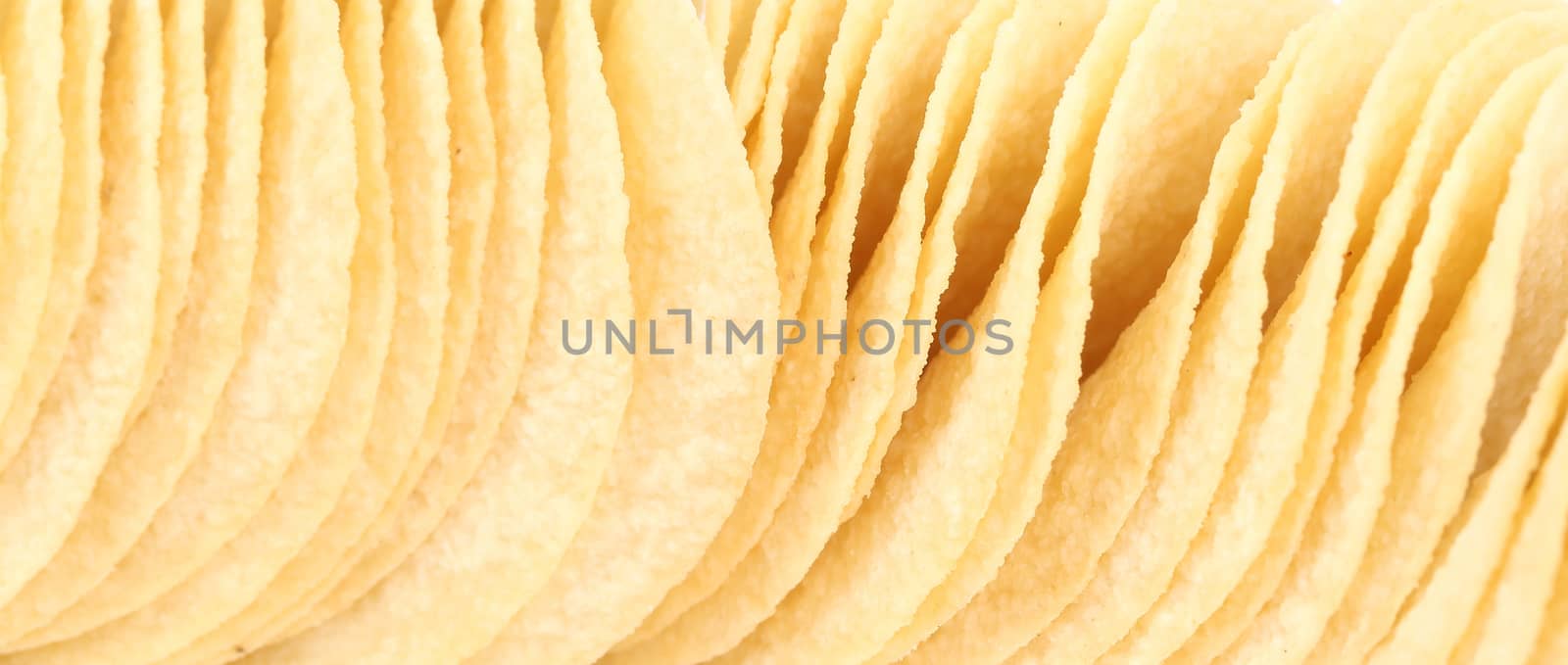 Close up of potato chips. by indigolotos