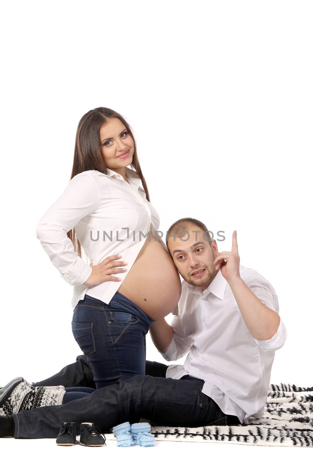Young couple expecting baby. Isolated on a white background.