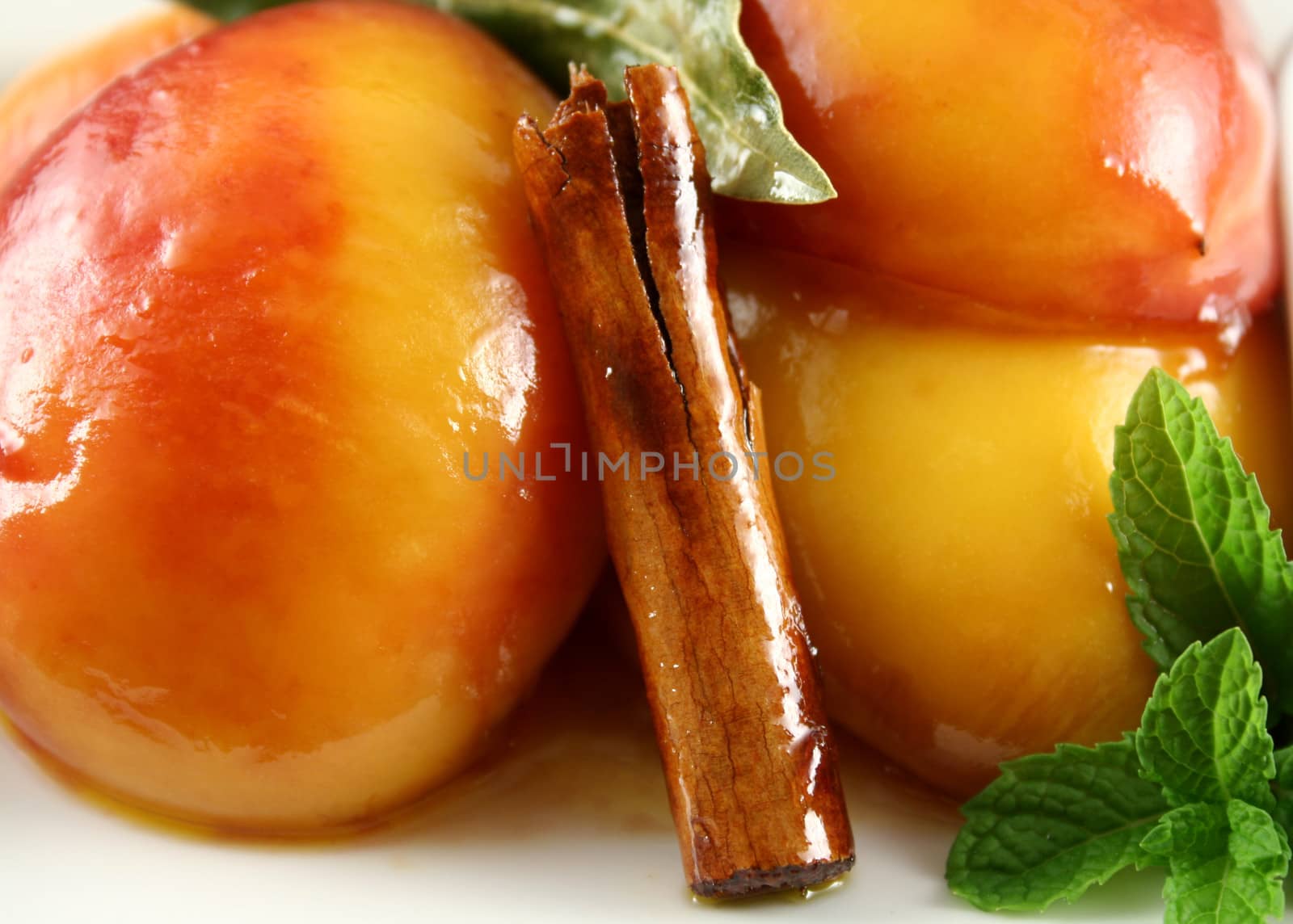 Background of poached nectarines with honey syrup nut yogurt and a cinnamon stick.