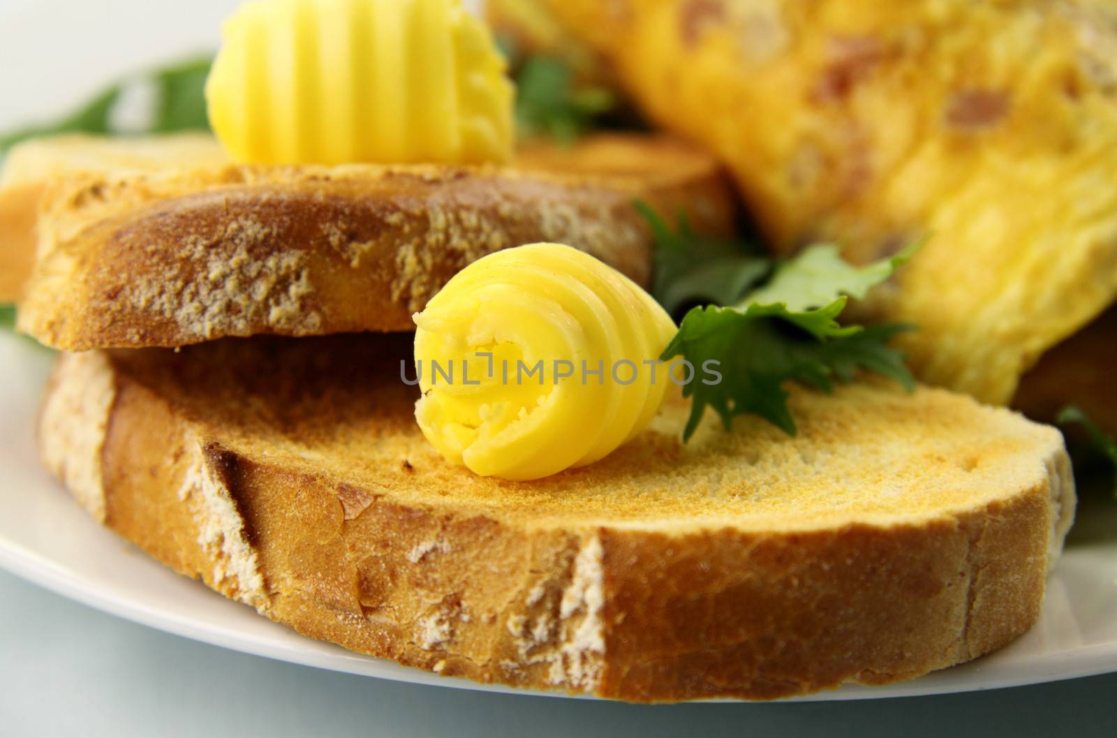 Scroll of butter on fresh toast ready to serve.