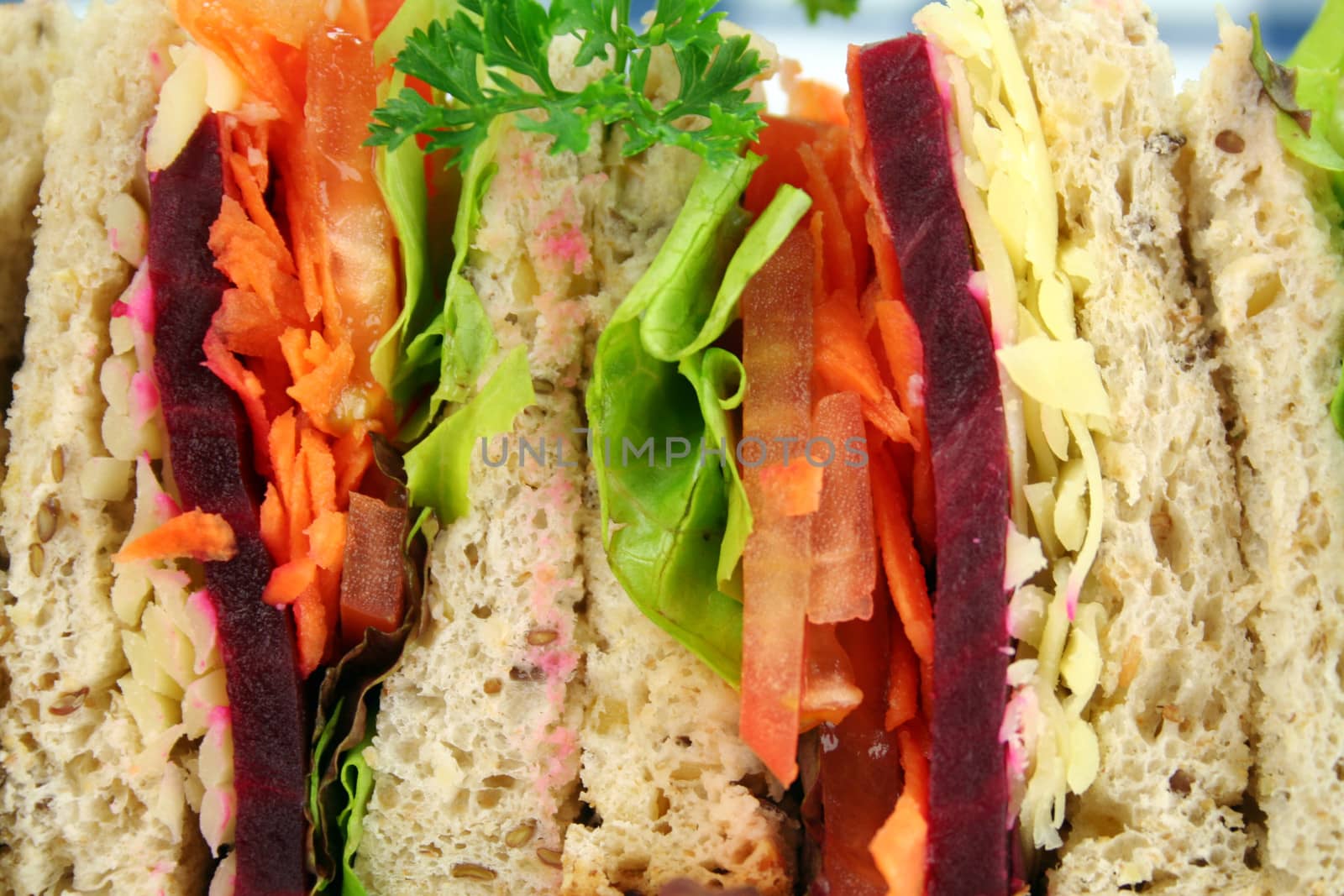 Colorful salad sandwich background made from sandwich quarters.