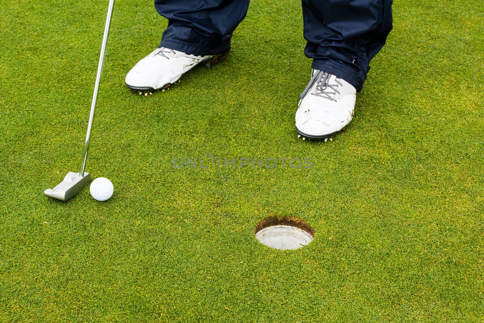 Golf player hitting the ball close-up on whole