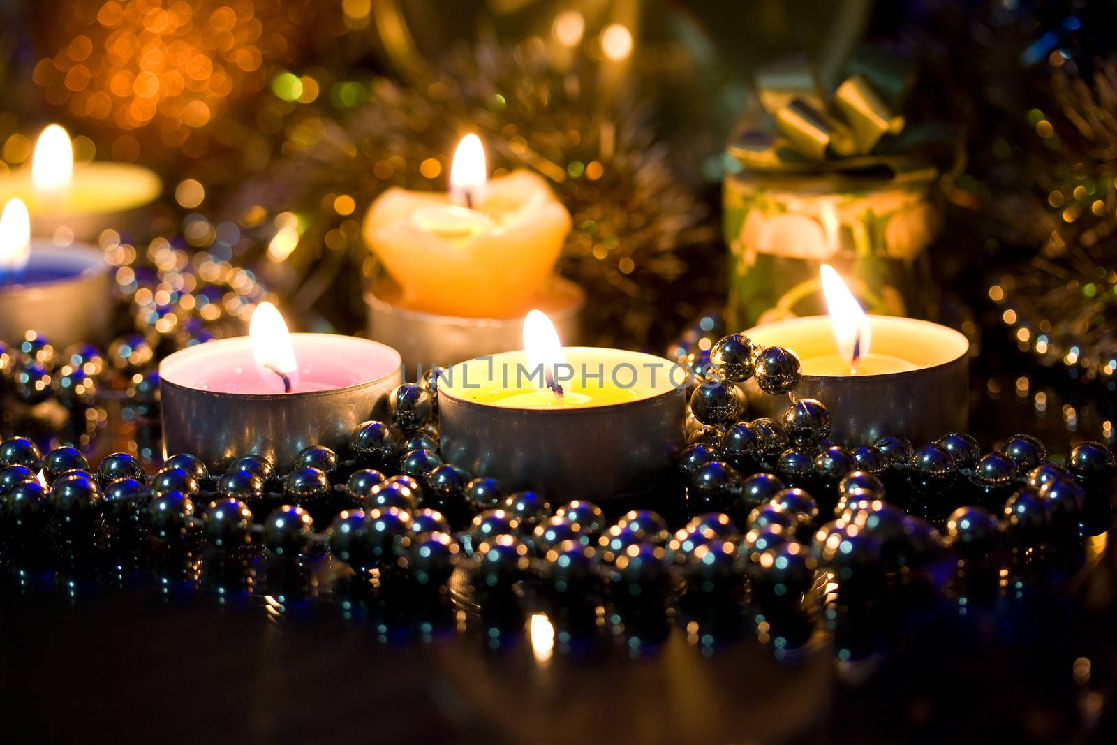 Lighted candles and gift on the background bokeh background