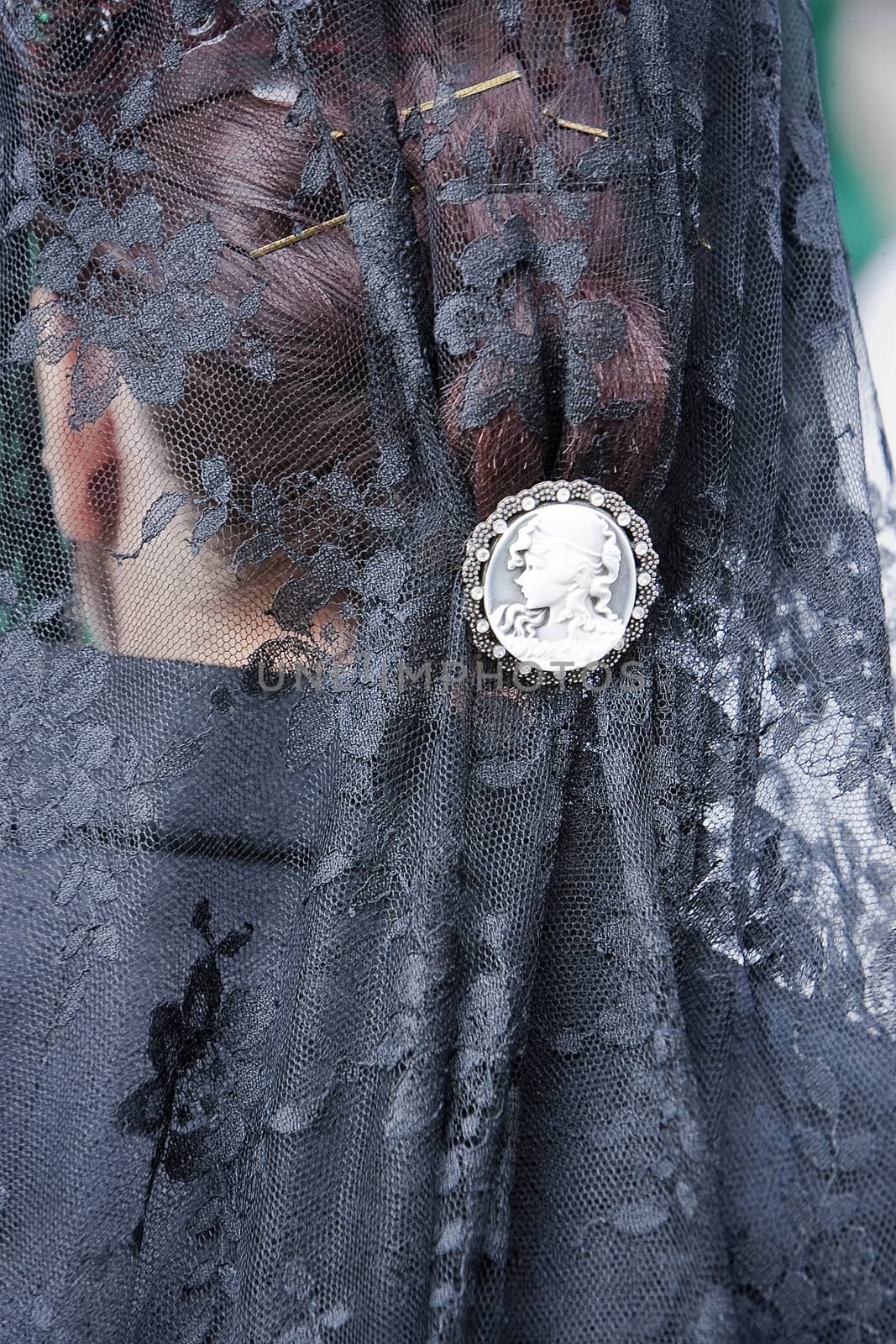 Detail of mantilla and touched embroidered black with silver snap during a procession of holy week, Andalusia, Spain
