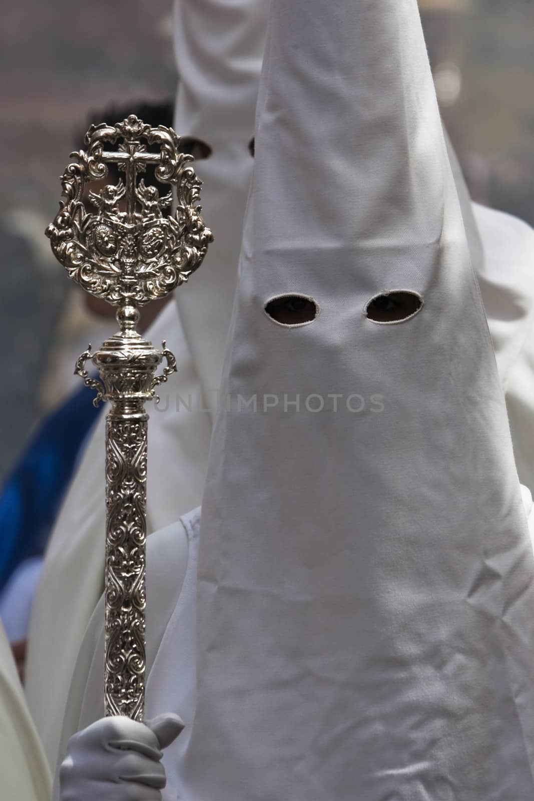 Penitent with staff of silver during a procession of holy week on Palm Sunday, Spain