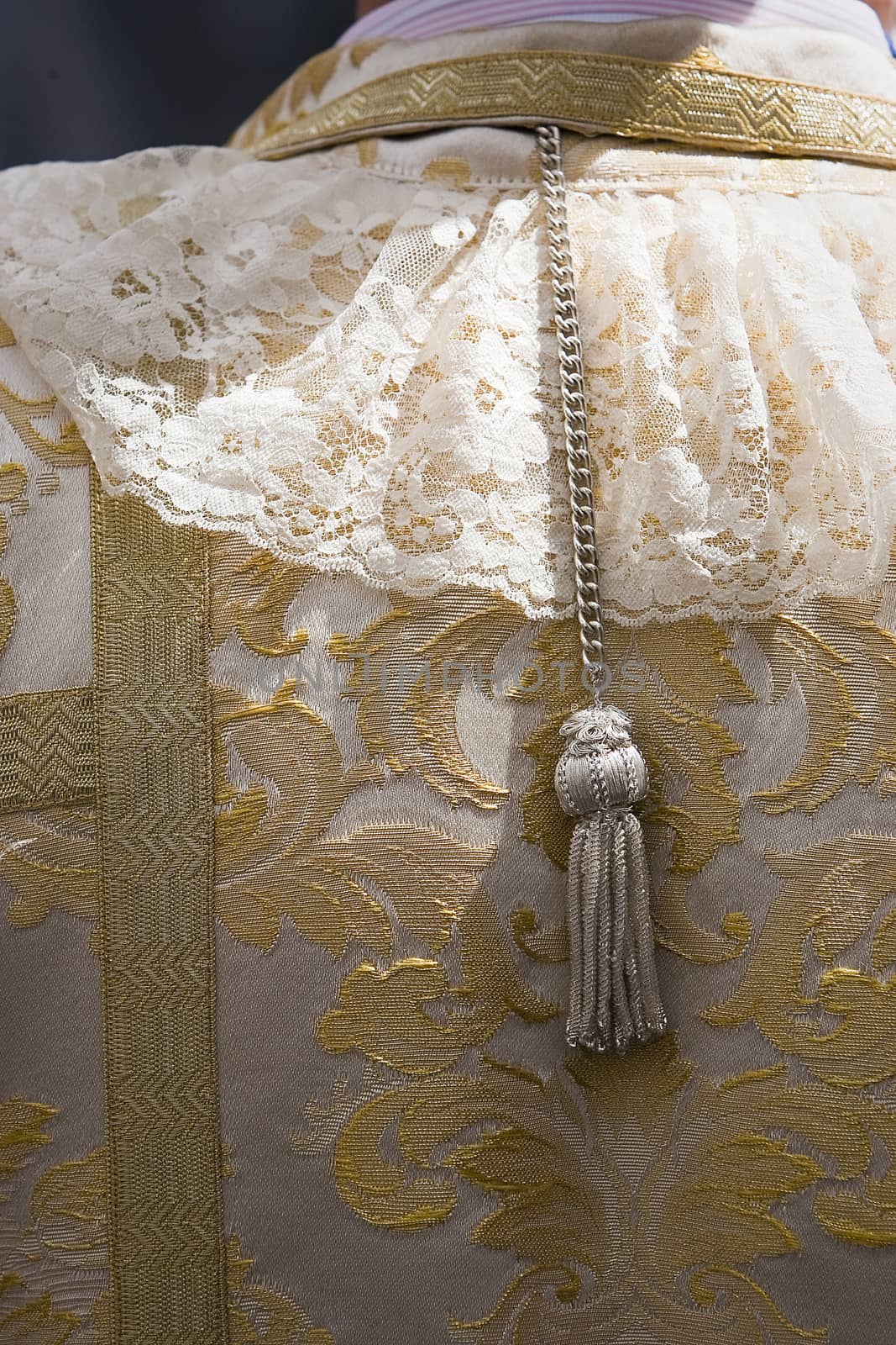 Detail of embroidery and tassel in a dalmatic, traditional dress of holy week in Spain