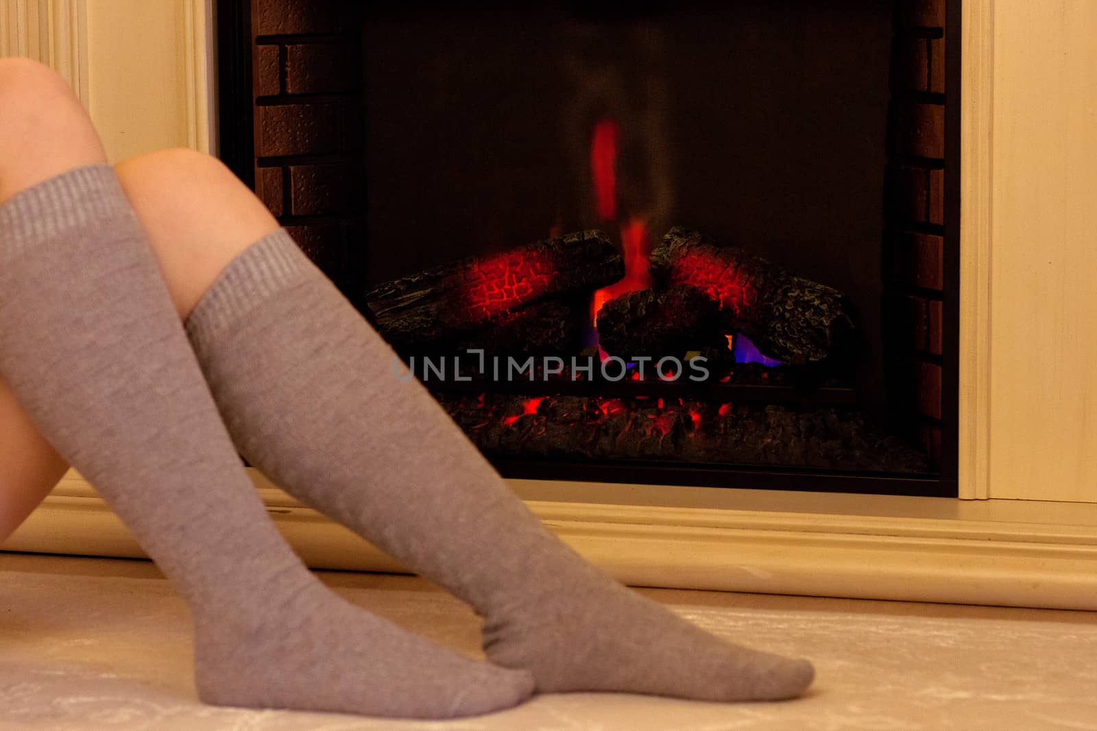 feet in socks on a background of fire by victosha