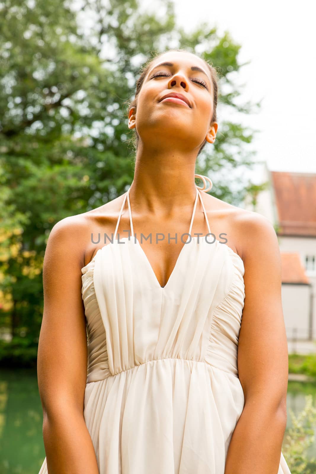 A young Girl in the park enjoying the sunlight.