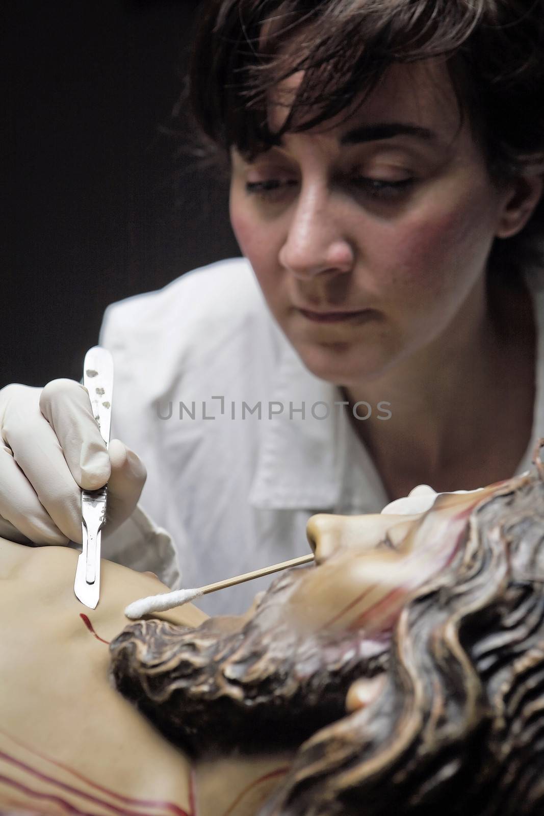 conservative restoring an image of Christ crucified on wood, Andalusia, Spain