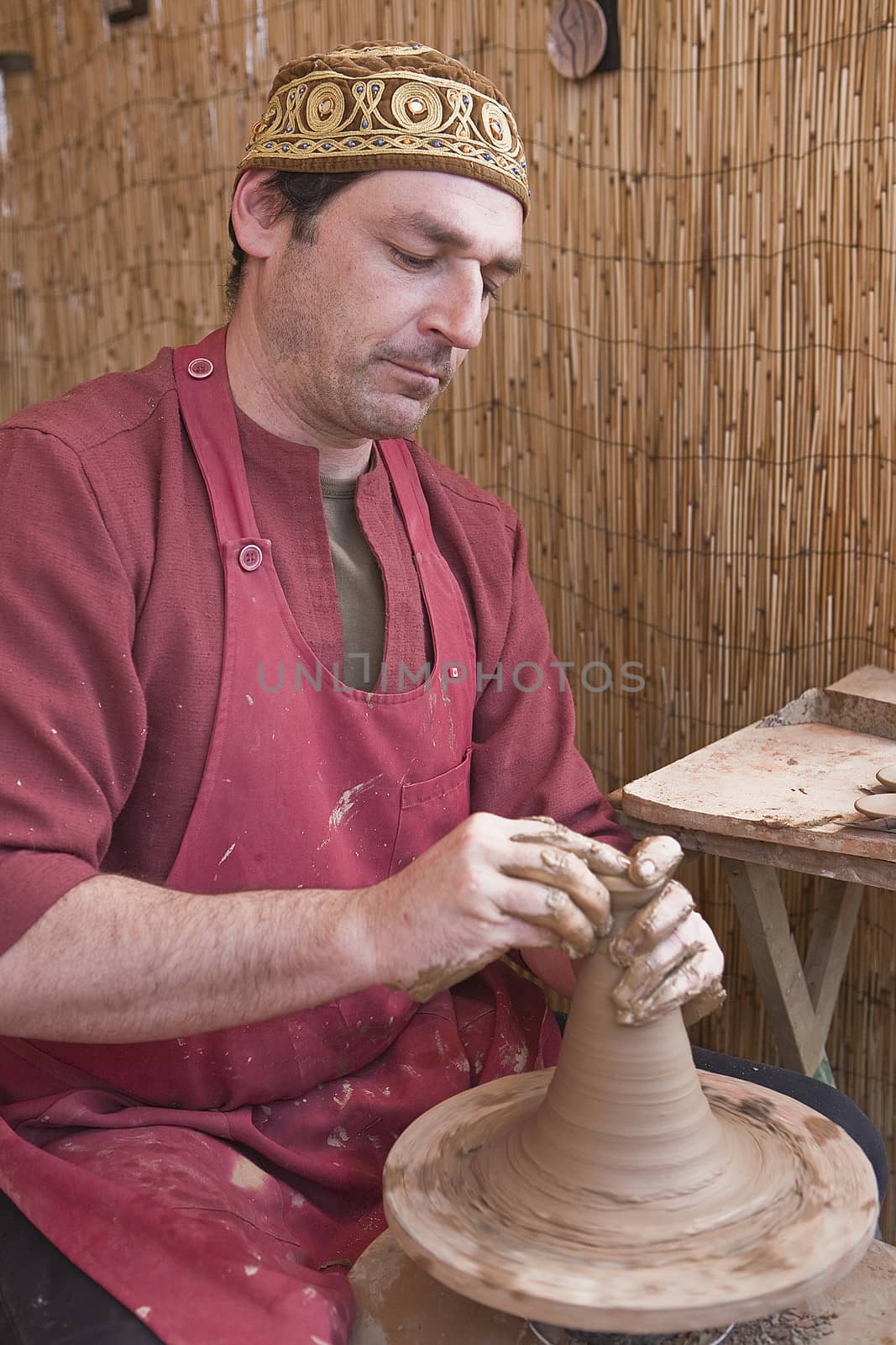 potter, creating an earthen jar on the circle, Andalusia, Spain