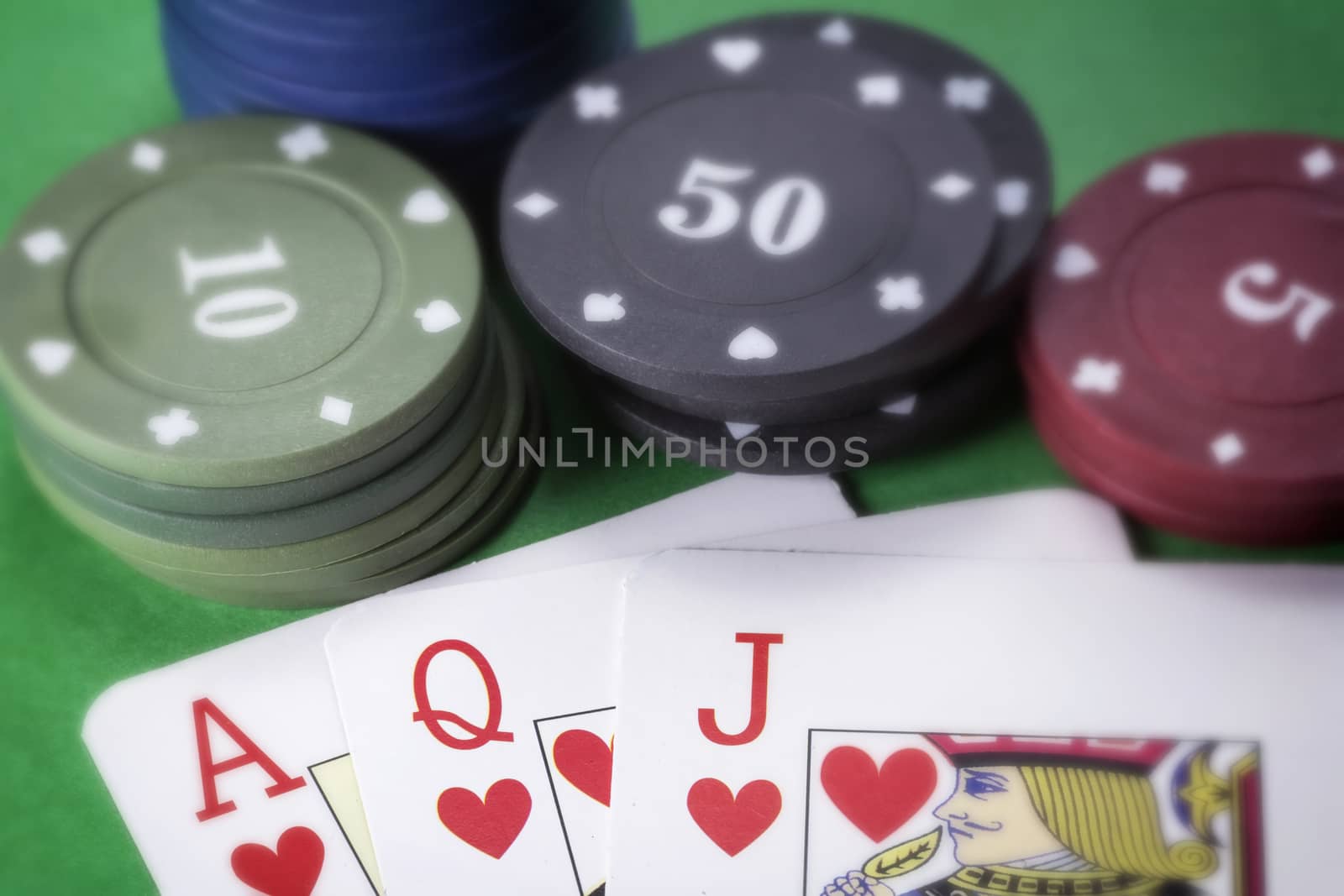 Poker chips and cards on green