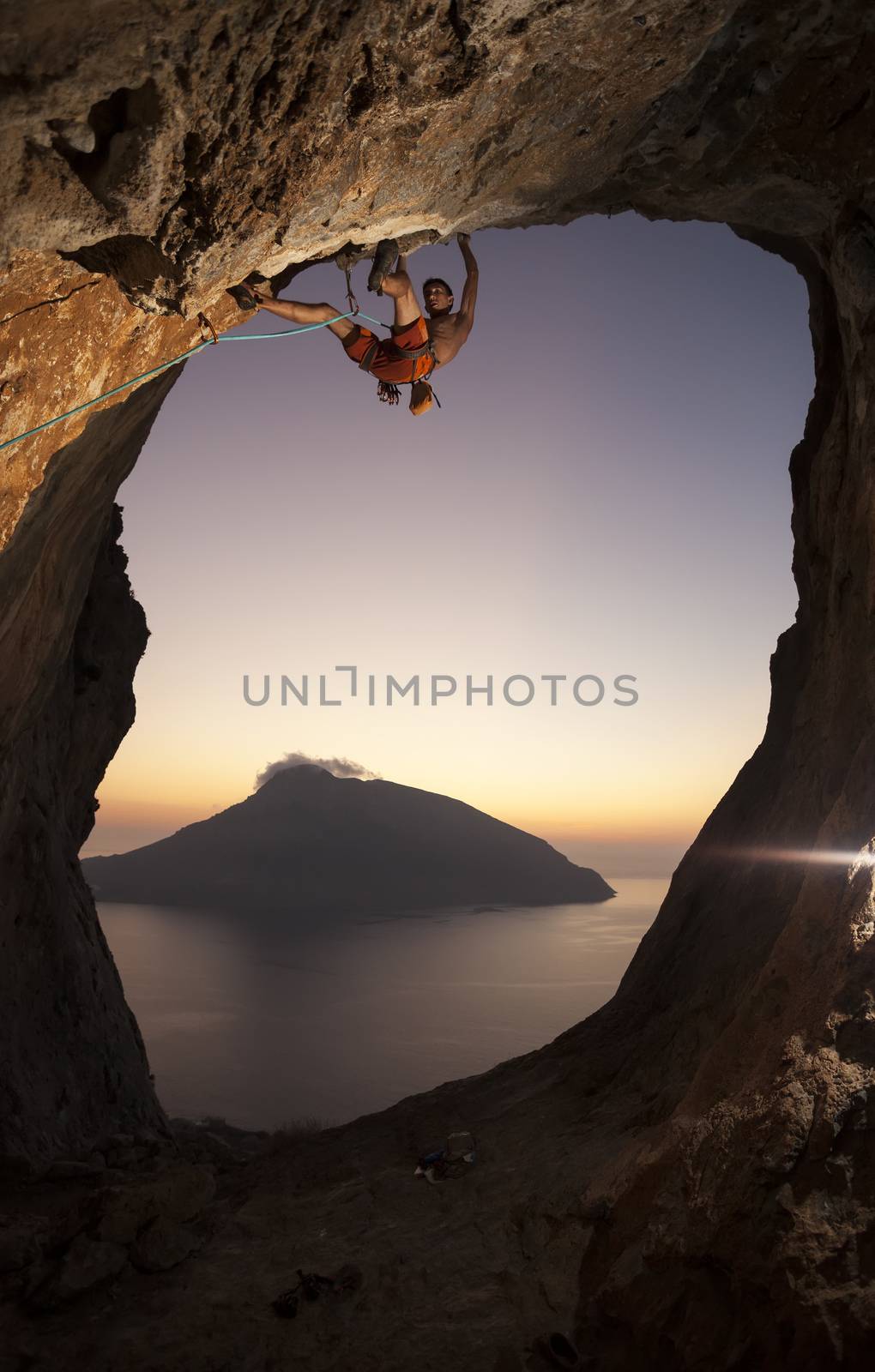Rock climber at sunset by photobac