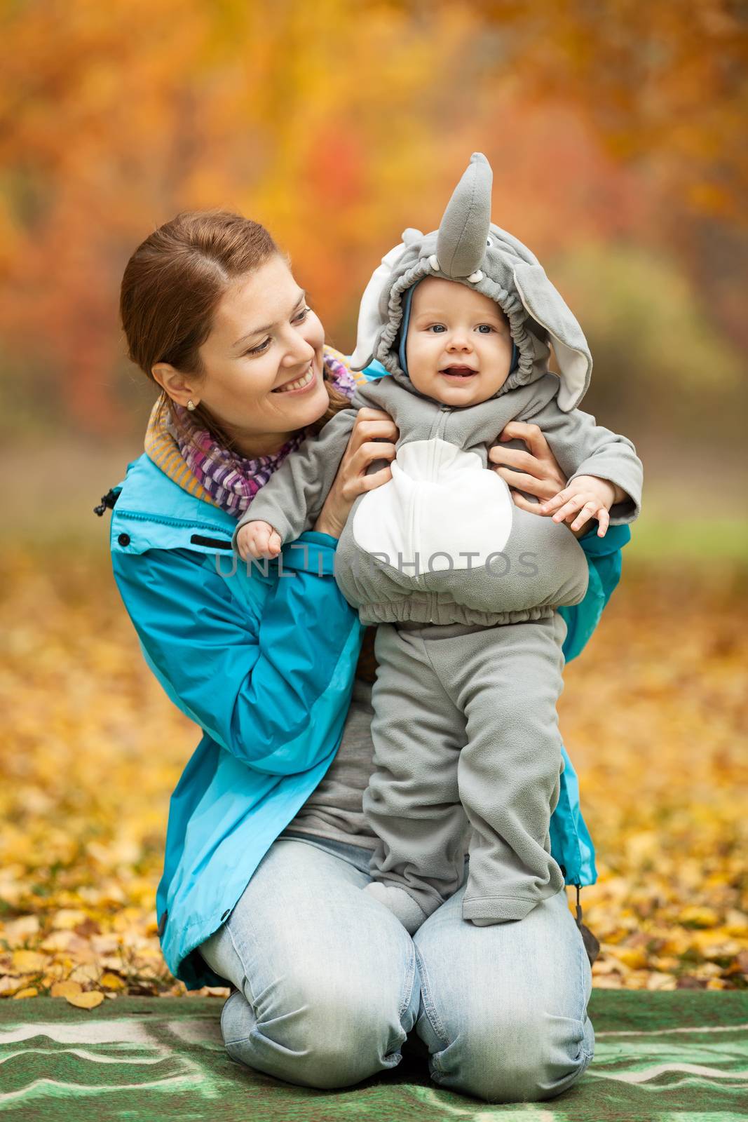 Young woman and her baby boy dressed in costume by photobac