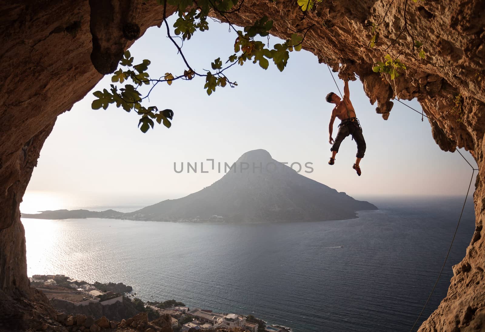 Rock climber at sunset. Kalymnos, Greece. by photobac