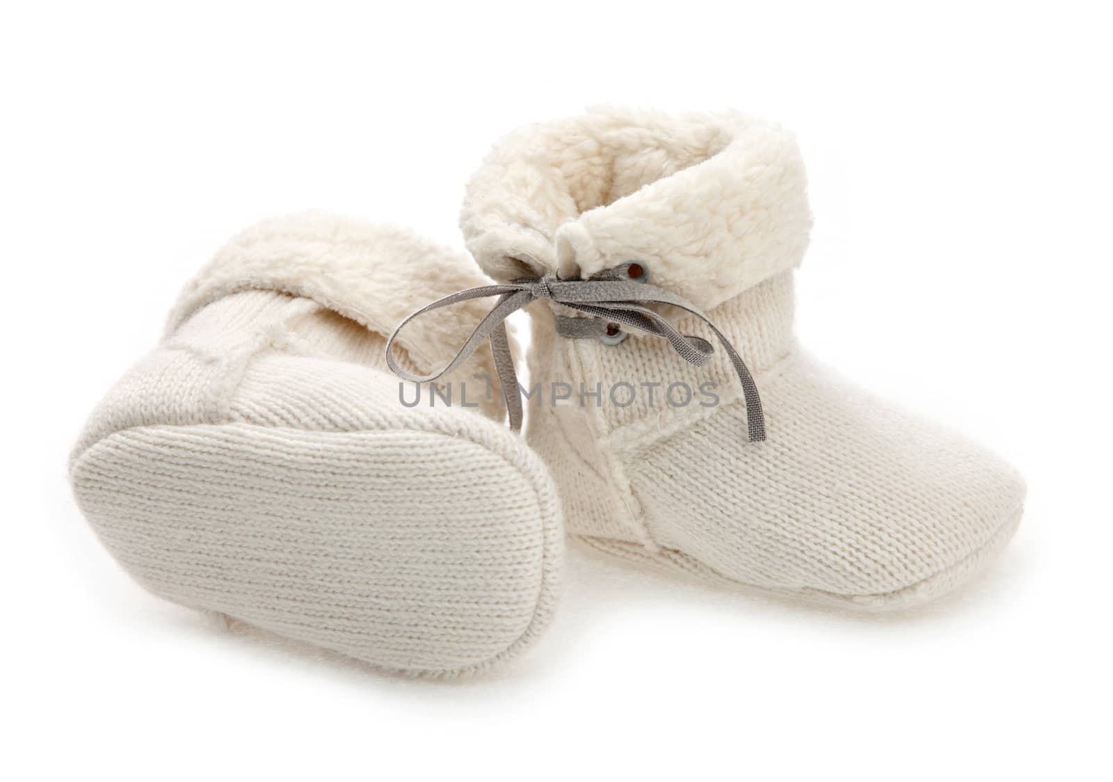 Pair of baby booties over white by photobac