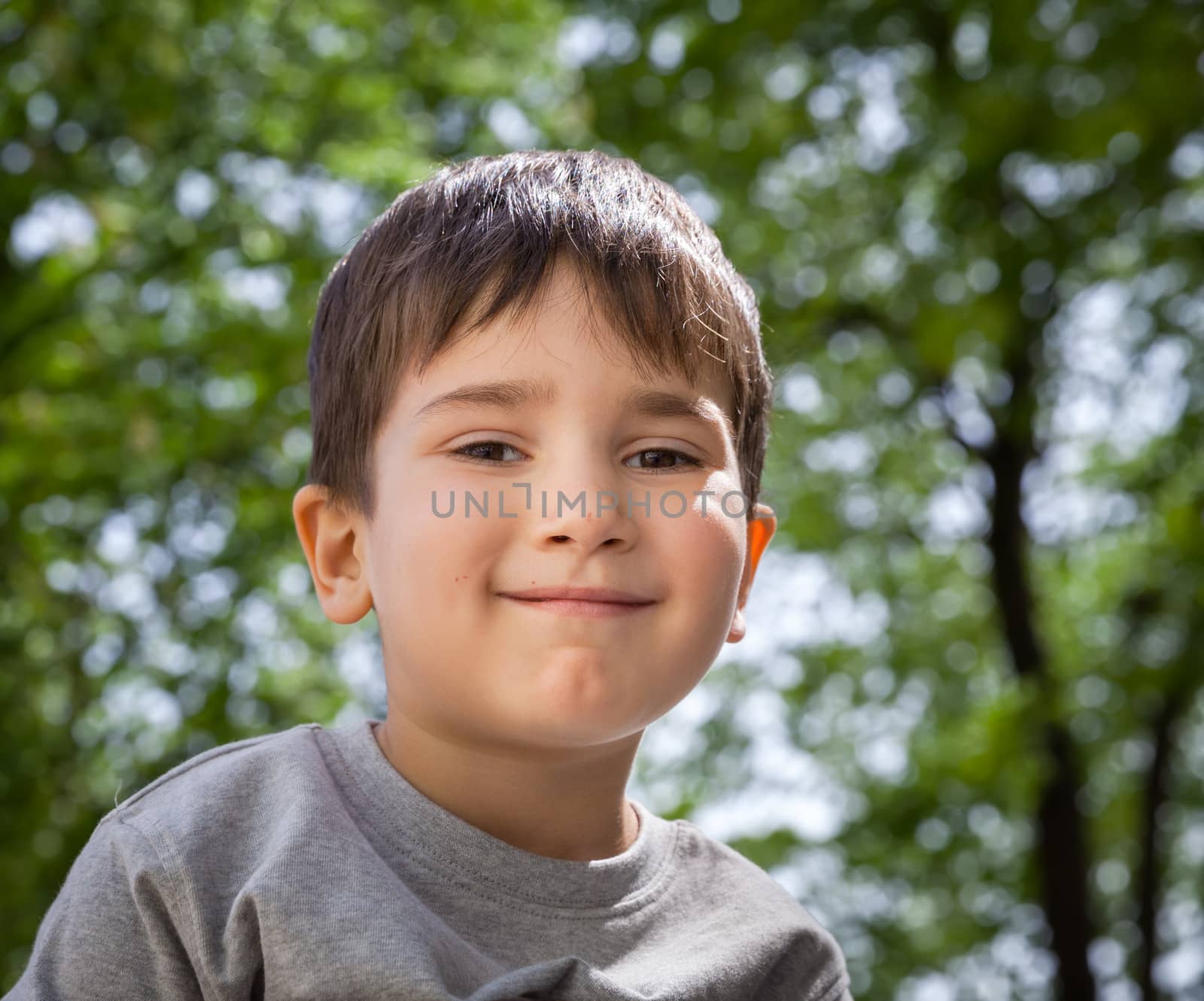 Happy little boy smiling on blurred background