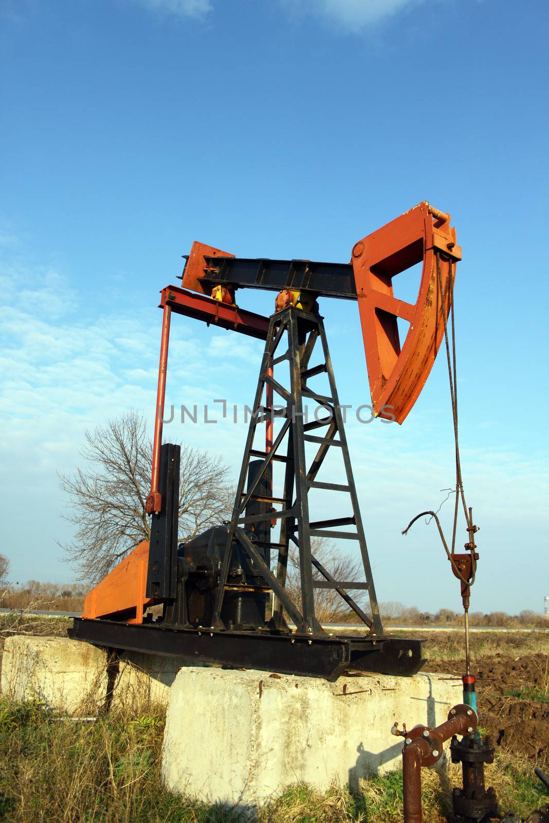 Oil pump jack working in the field 