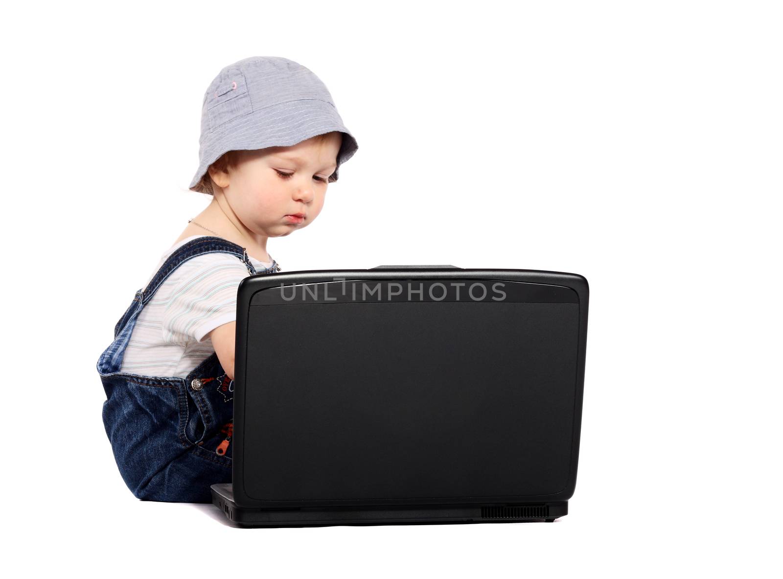 Little boy sitting with a laptop isolated on the white