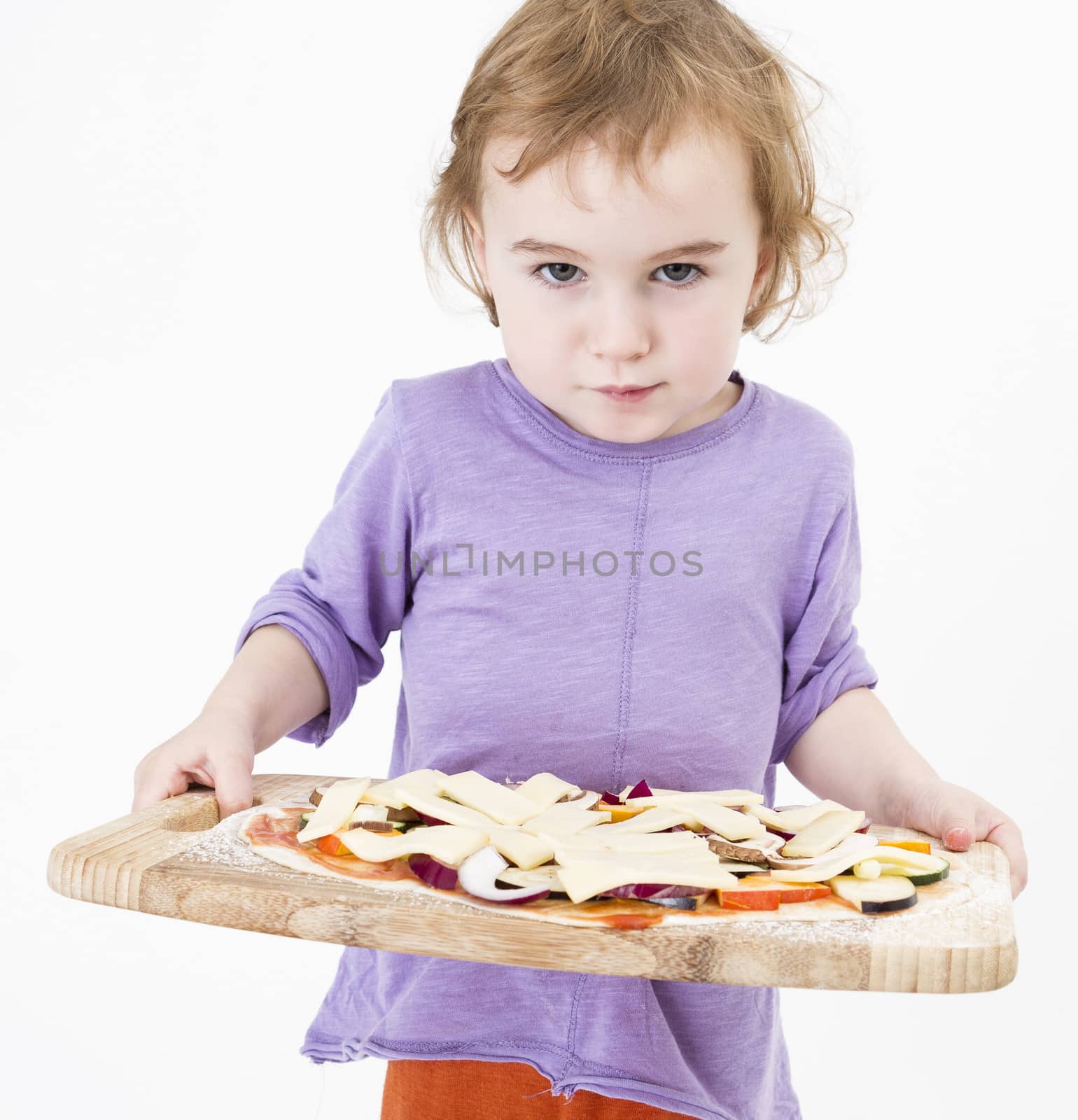 cute young girl holding plate with fresh pizza. studio shot in grey background